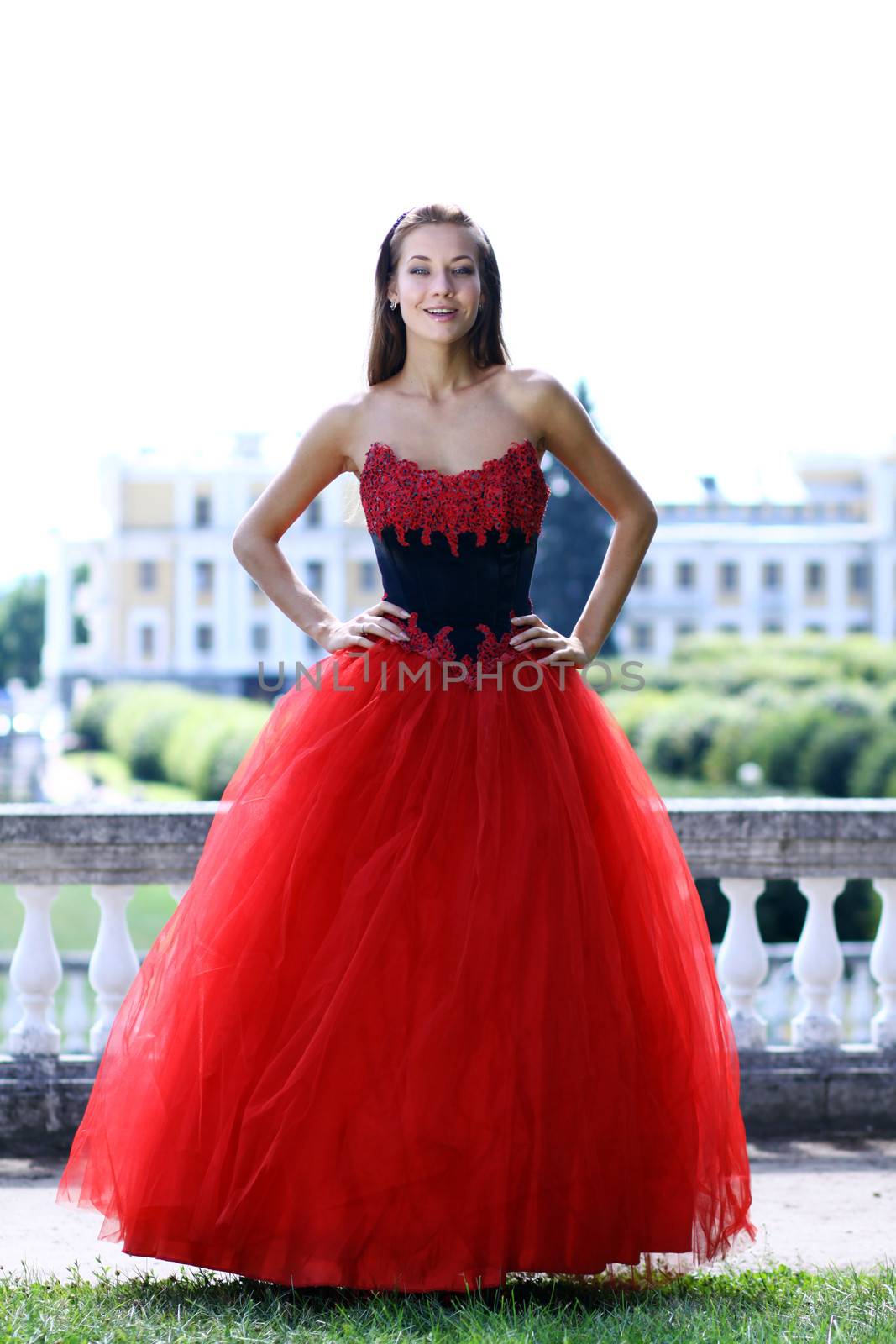 Young woman in a red gothic dress