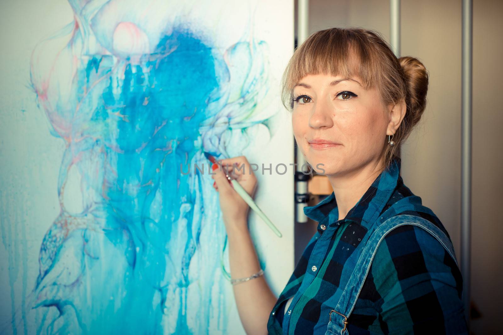 beautiful blonde woman painter in her studio