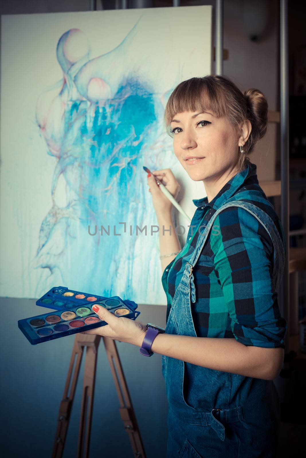 beautiful blonde woman painter in her studio