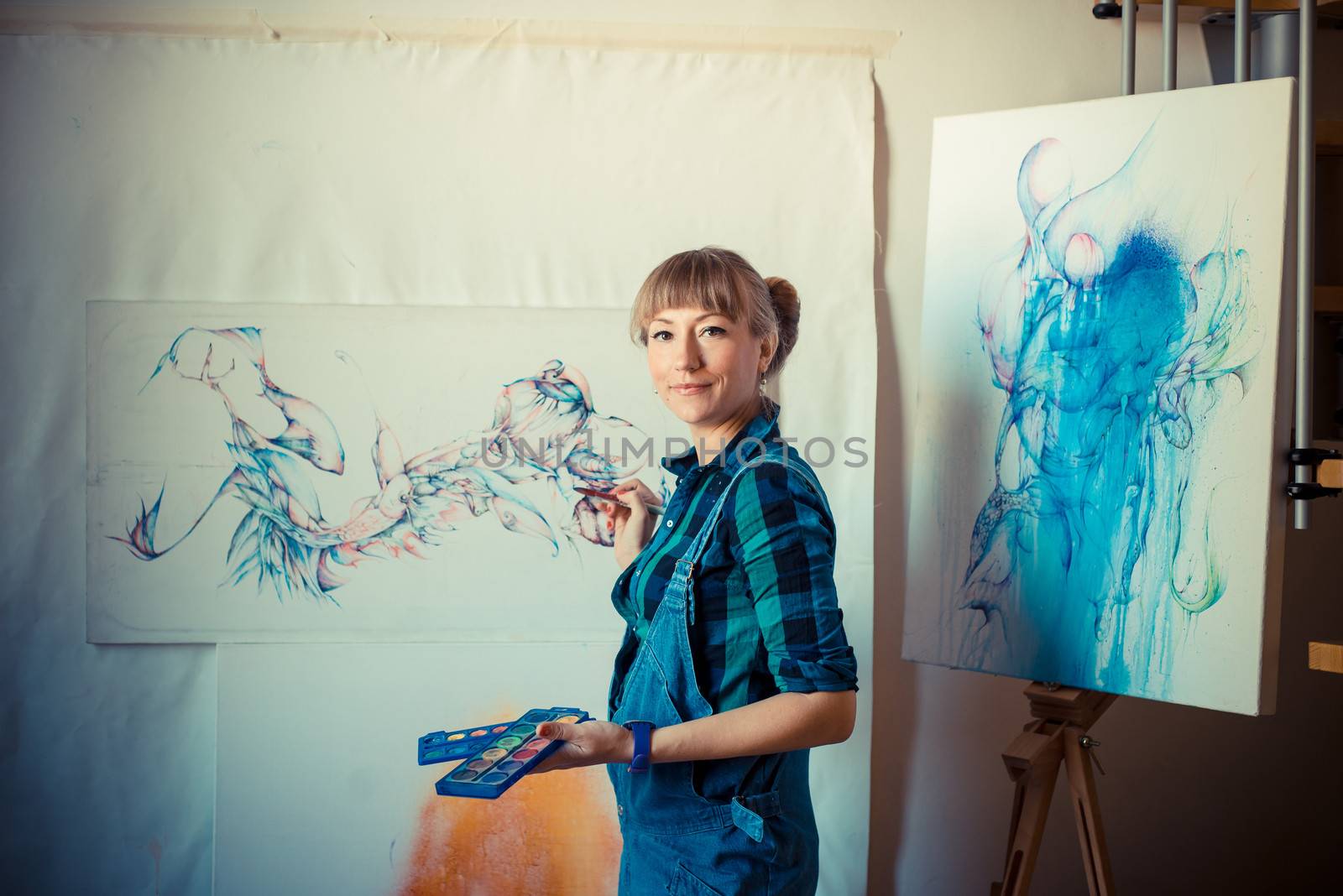 beautiful blonde woman painter in her studio