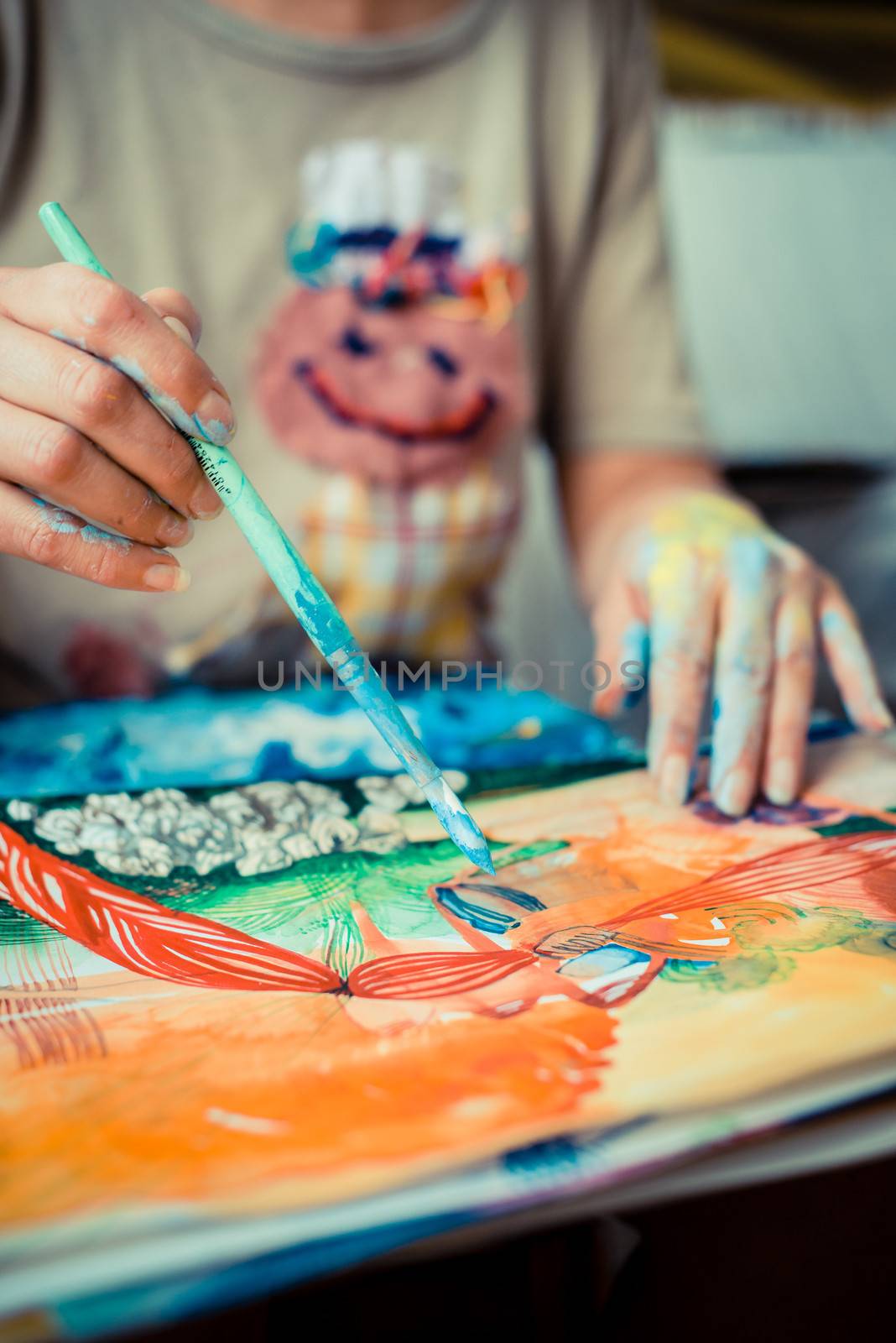 particular of woman painter hand painting in her studio