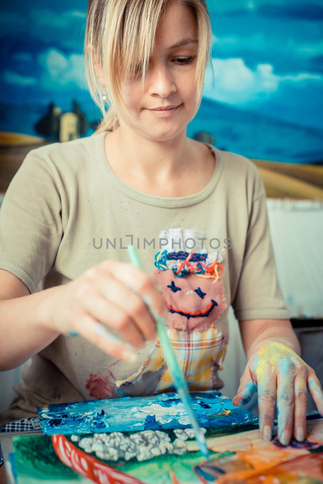 beautiful blonde woman painter in her studio