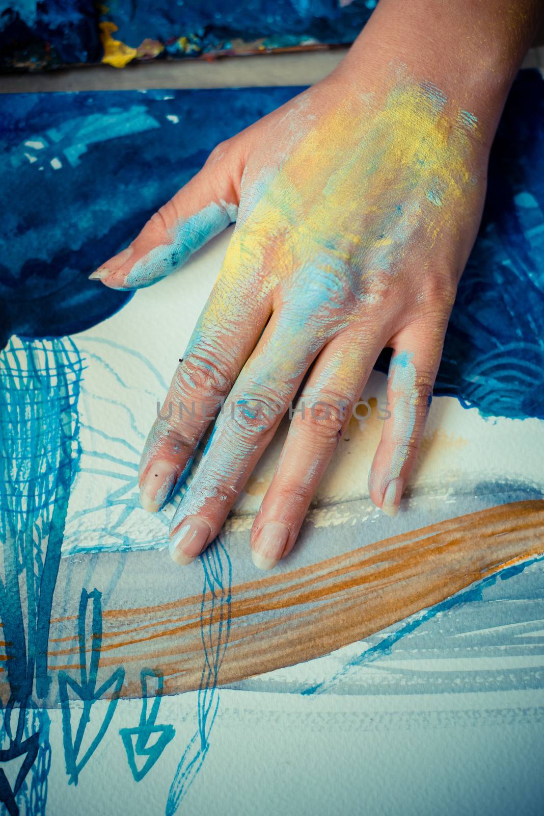 particular of woman painter hand painting in her studio