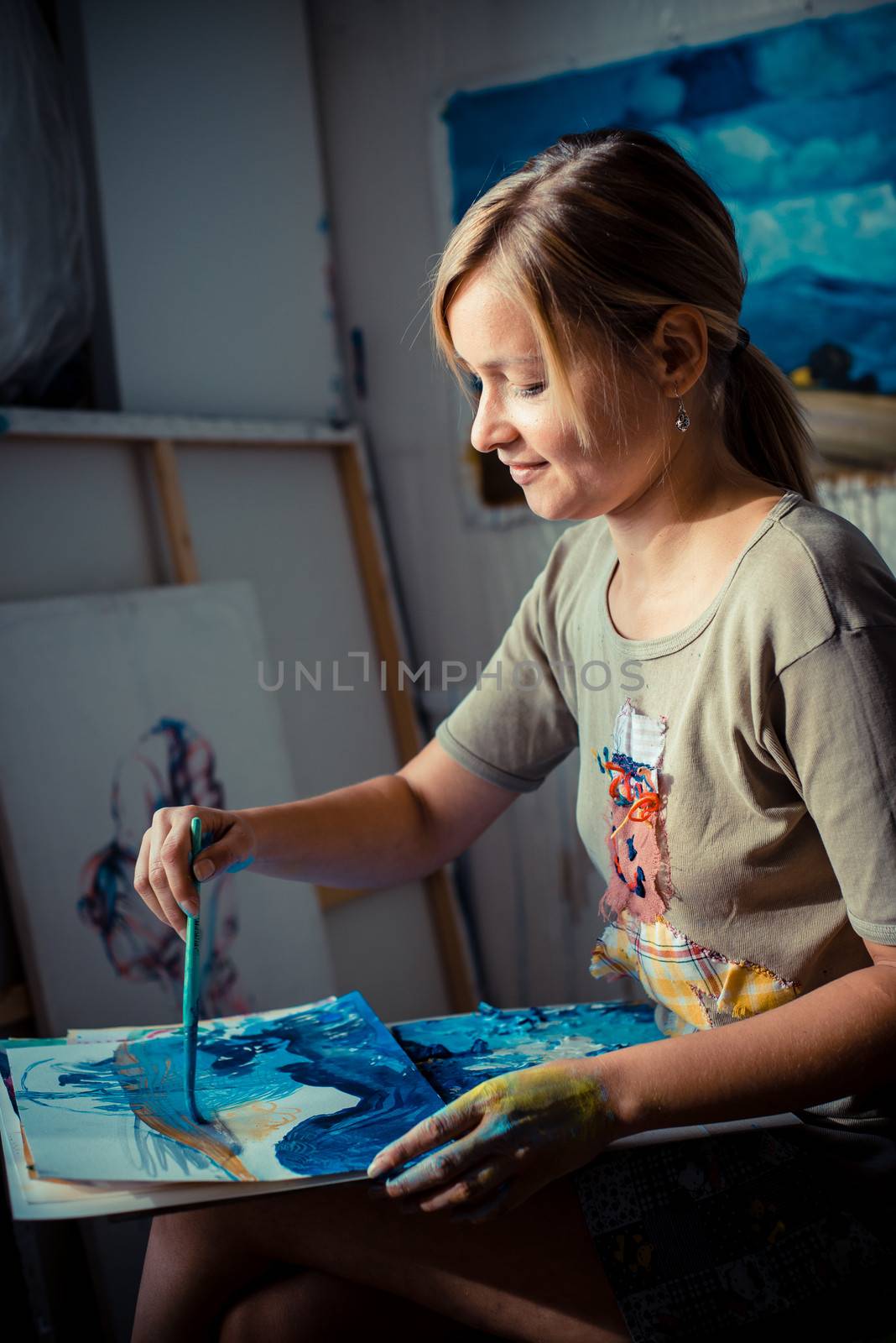 beautiful blonde woman painter in her studio