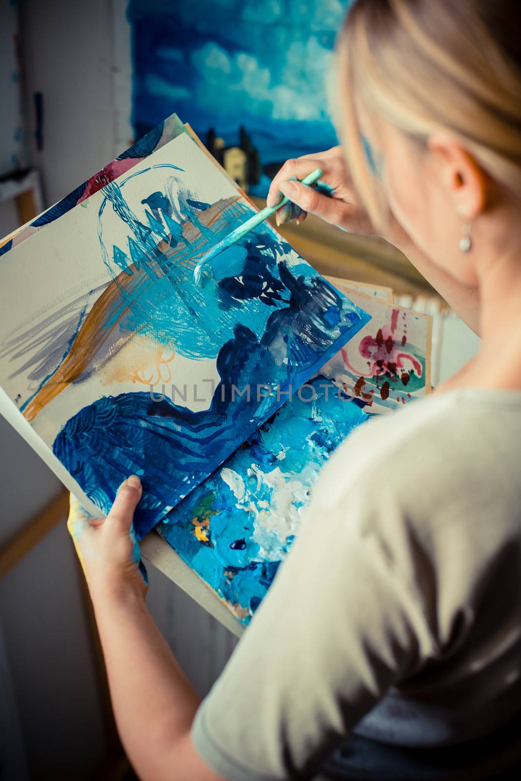 beautiful blonde woman painter in her studio