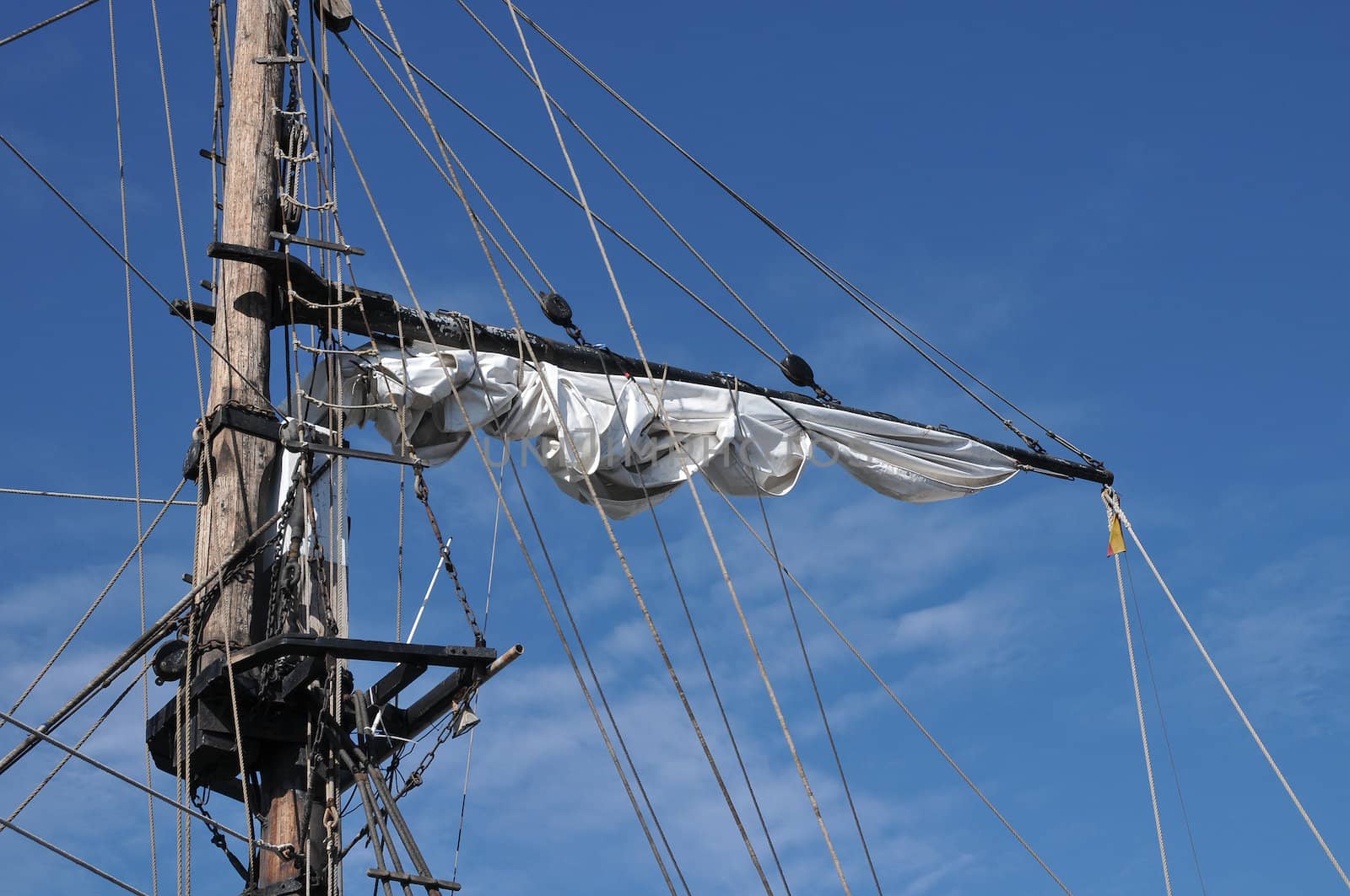 old sailing boat mast over a blue sky