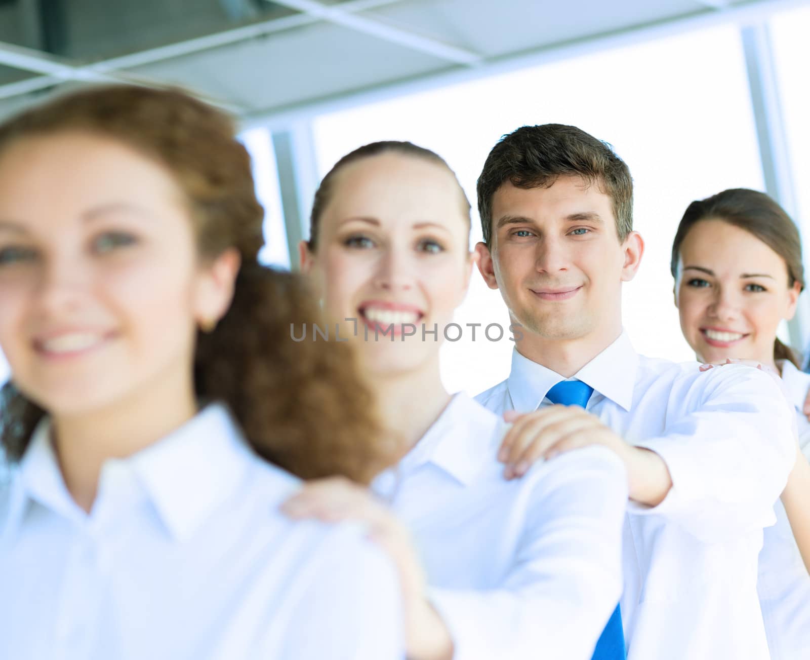 portrait of a young businessman standing in a row with his colleagues, concept of teamwork