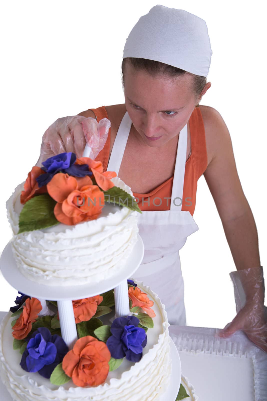 Woman with white bandanna giving to a wedding cake latest small retouches, isolated on white background