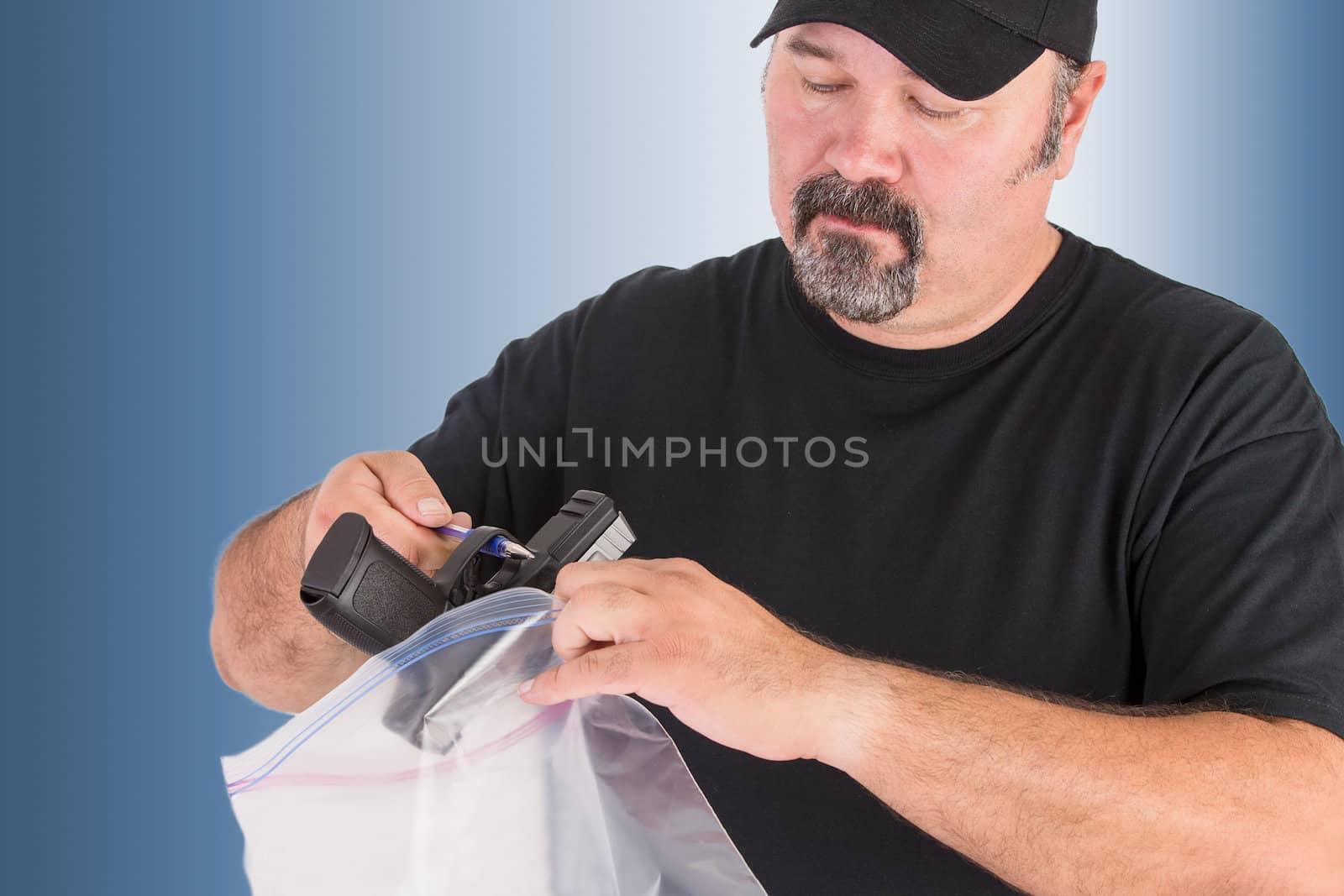 Crime scene investigator founds a gun, he is placing the gun in to a evidence bag seriously without touching for further analysis, isolated on light blue background