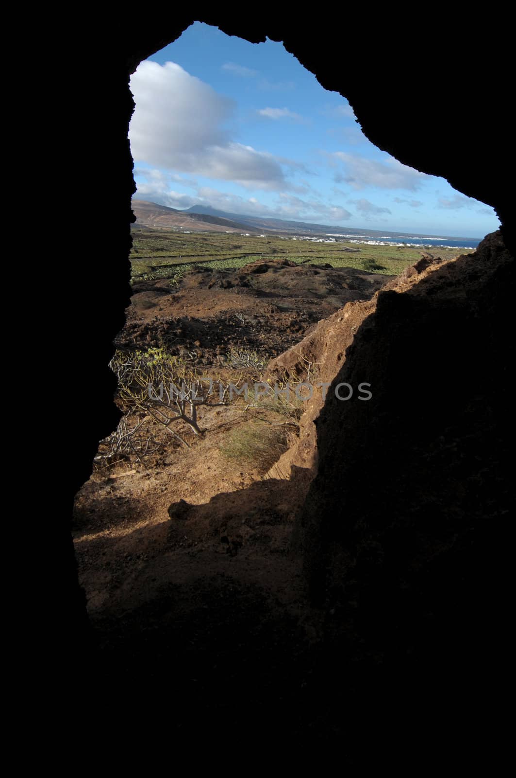 Cave near a volcano in the desert by underworld