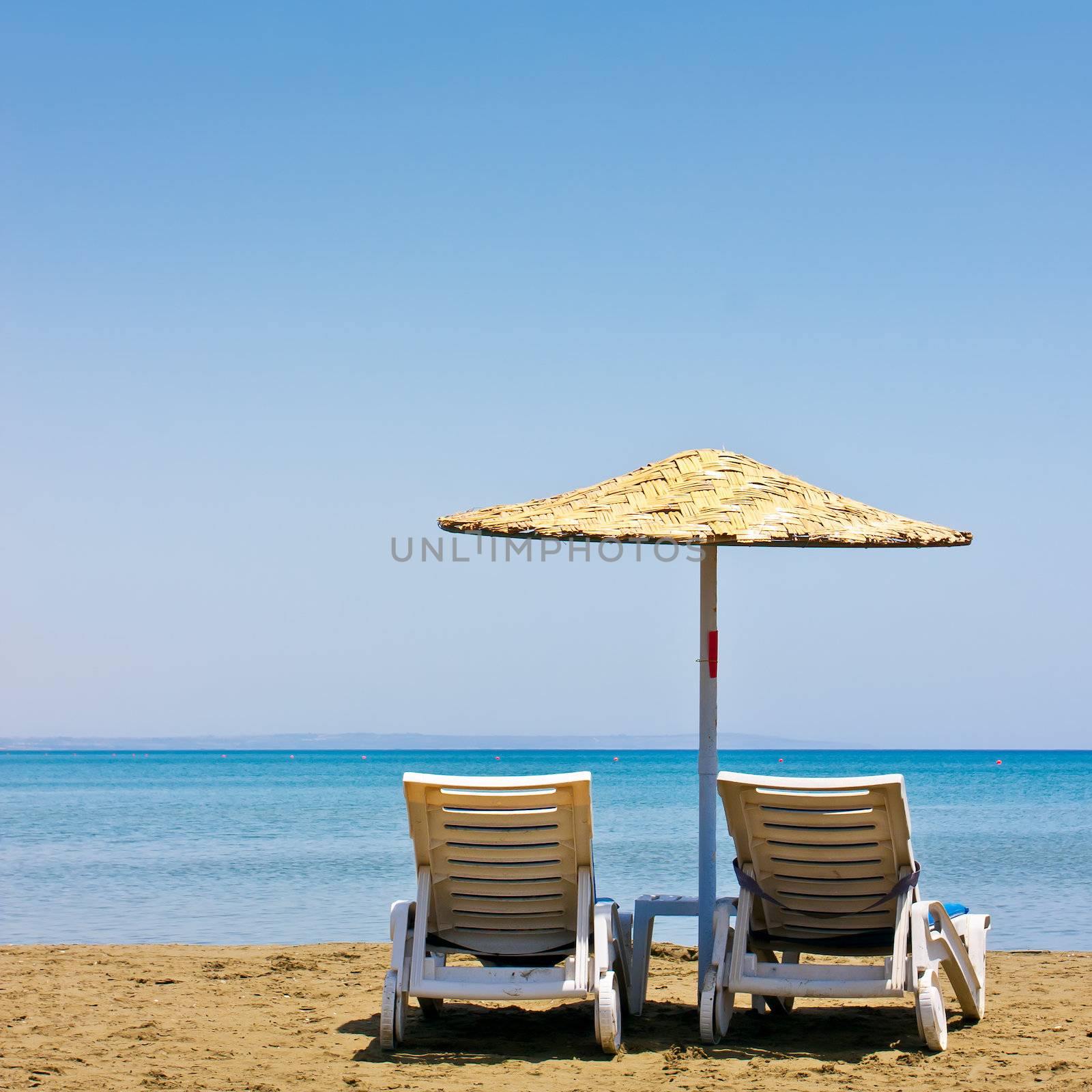 Two old beach chairs and umbrella