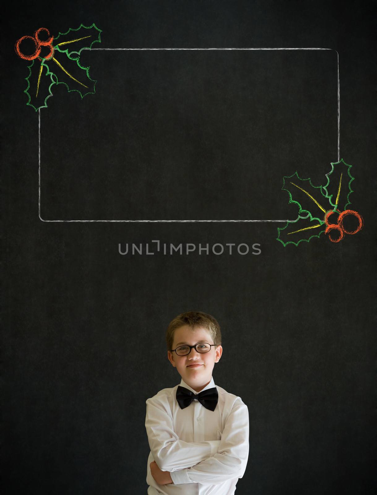 Thinking boy dressed up as business man with Christmas holly to do checklist on blackboard background