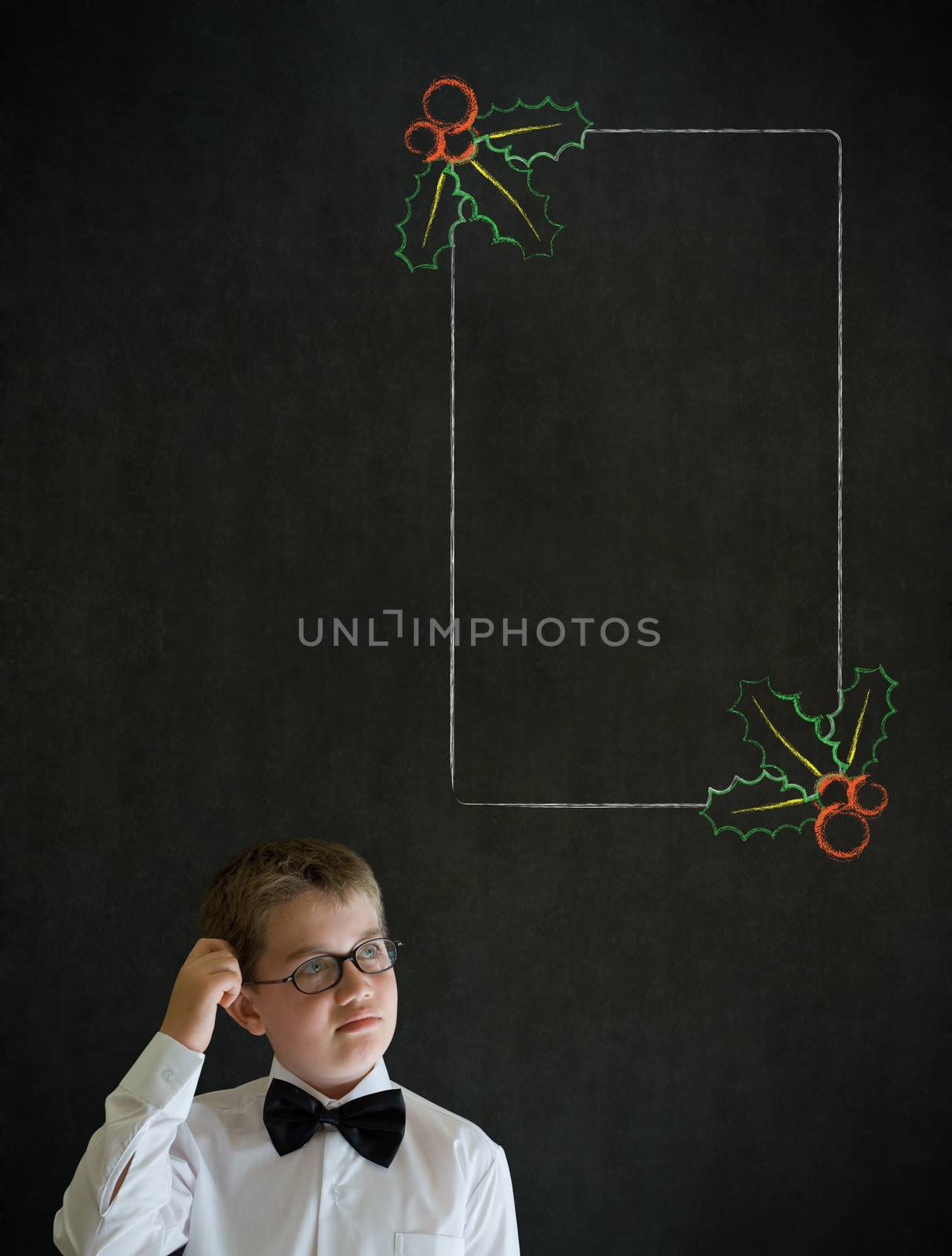Scratching head thinking boy dressed up as business man with Christmas holly to do checklist on blackboard background