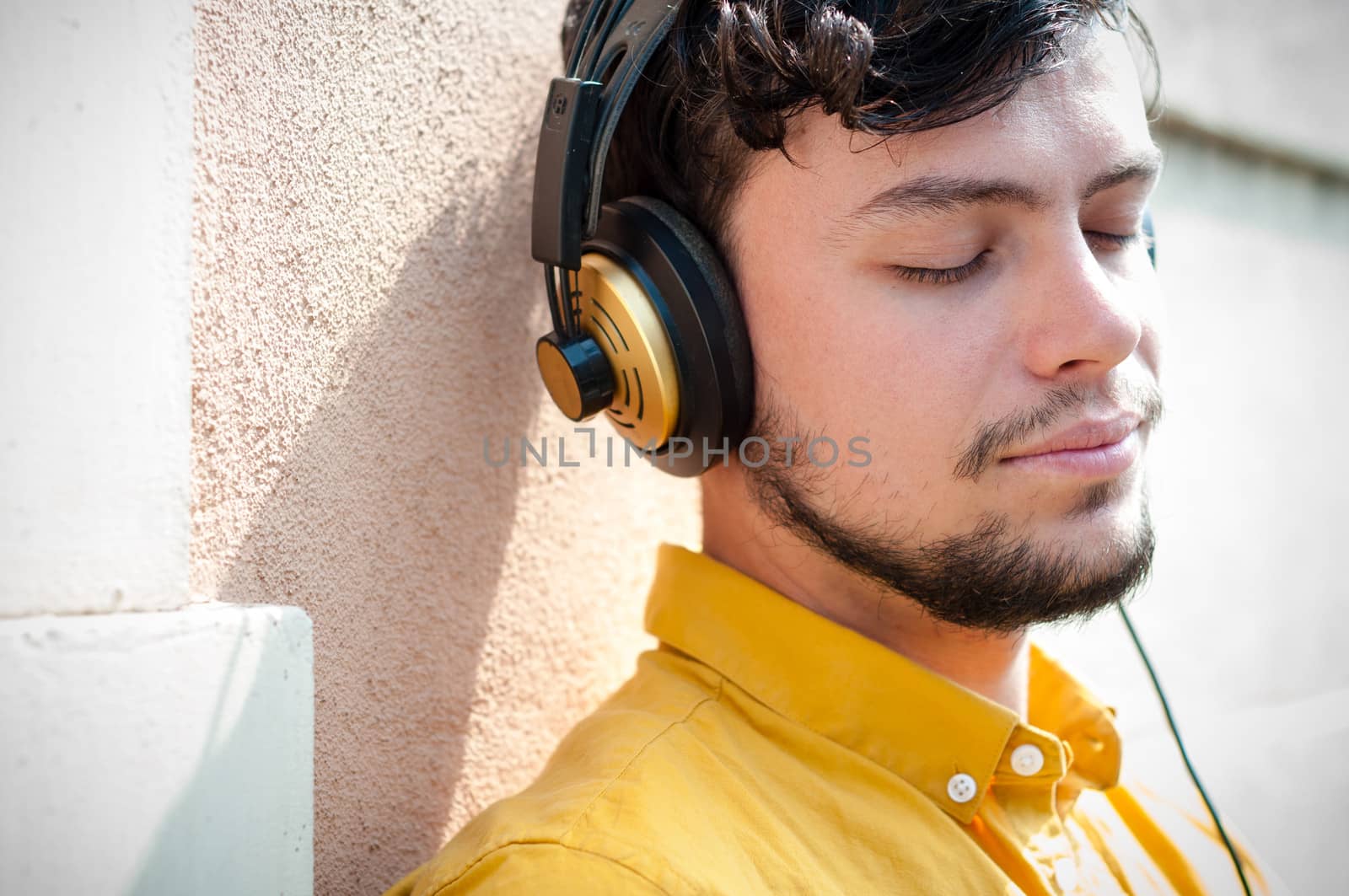 hipster young man listening to music on the balcony 