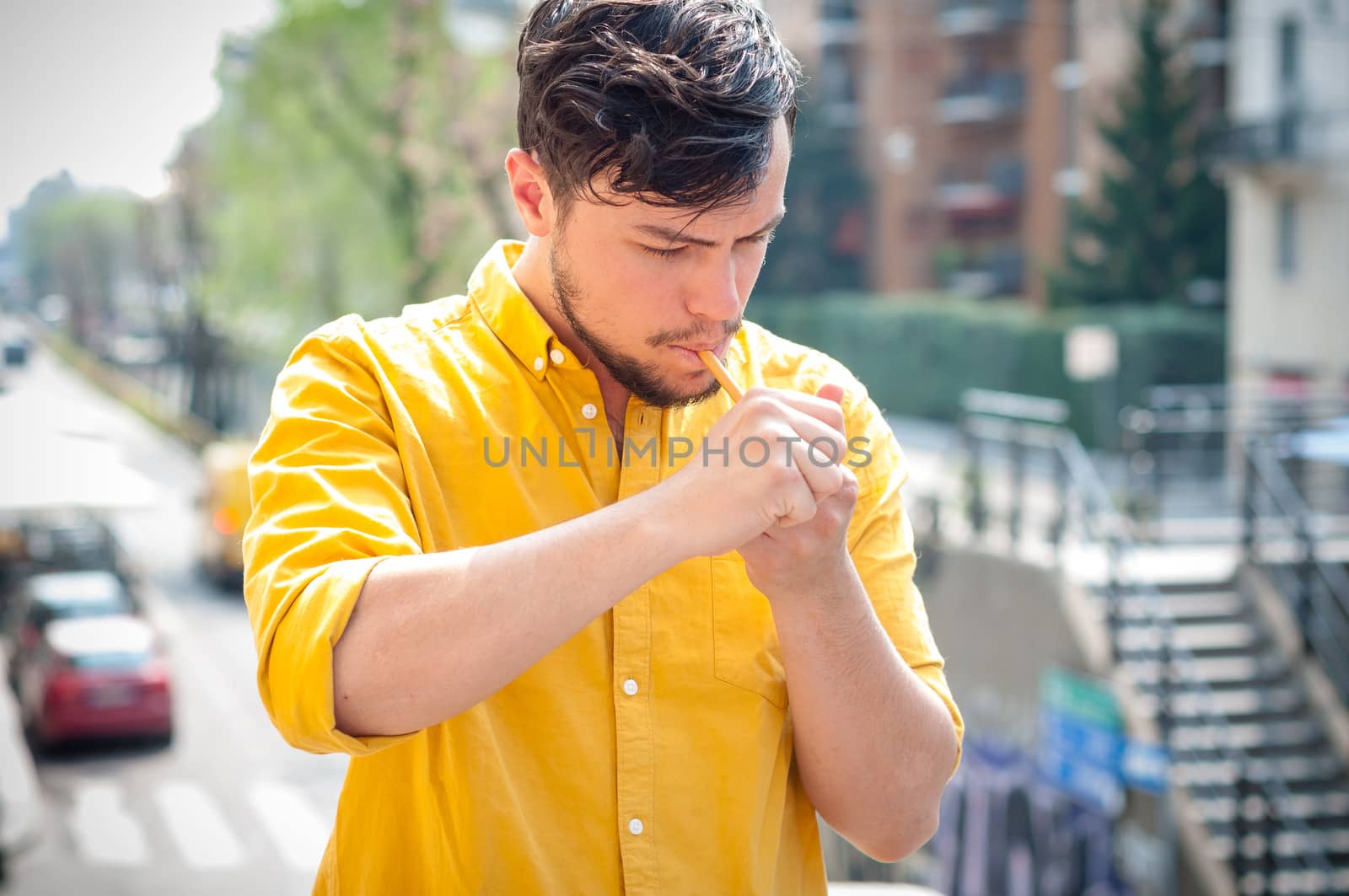 young man smoking pipe on the balcony