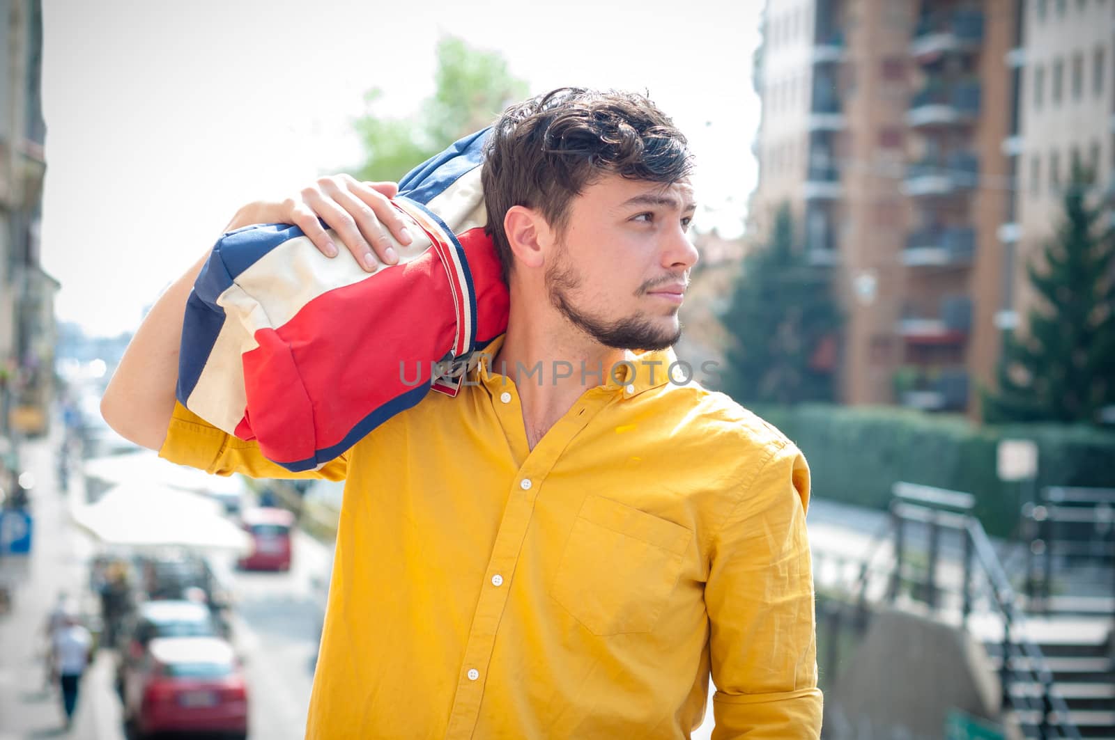 hipster young man with bag in the city