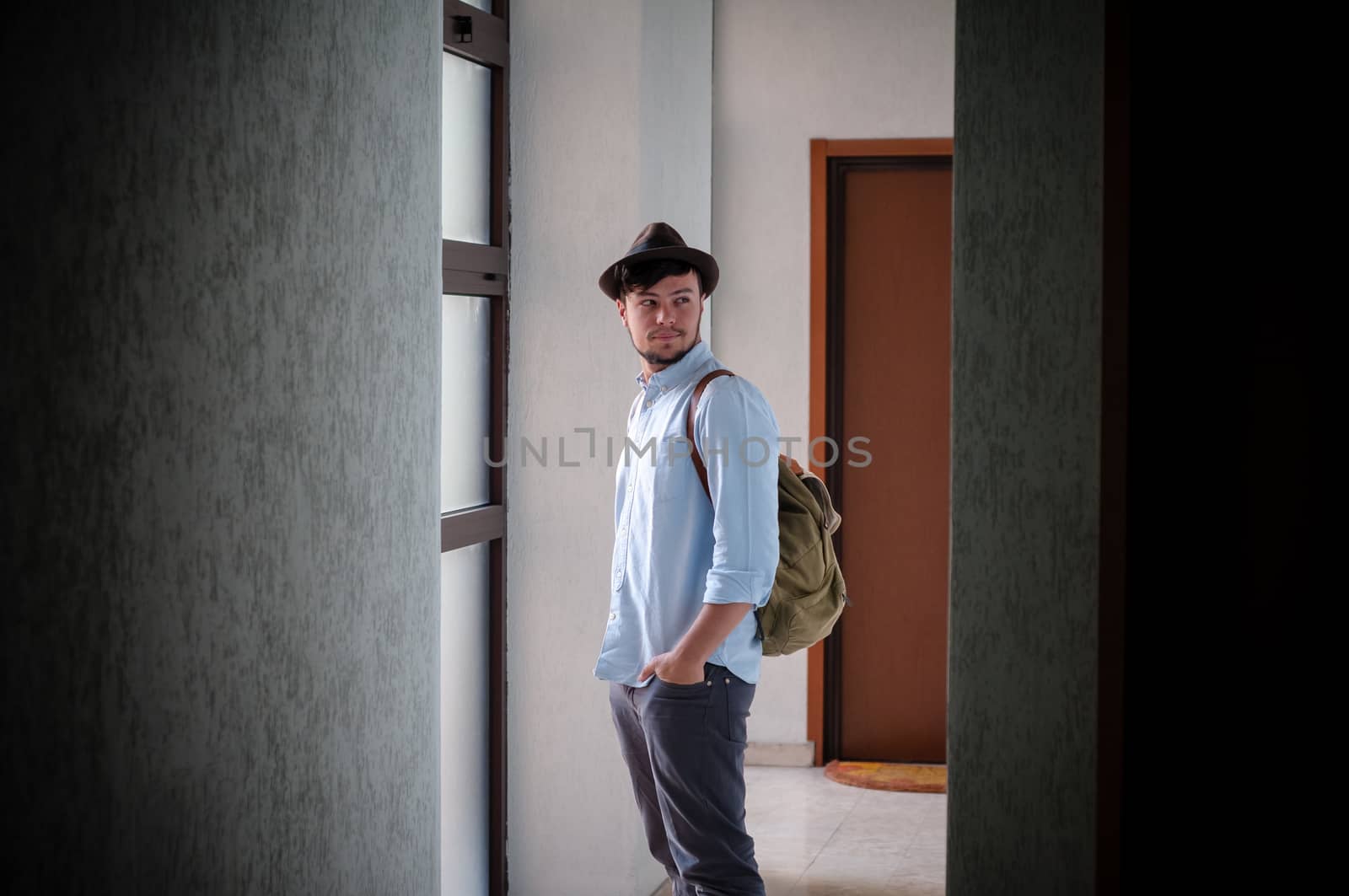 hipster young man posing in a hallway