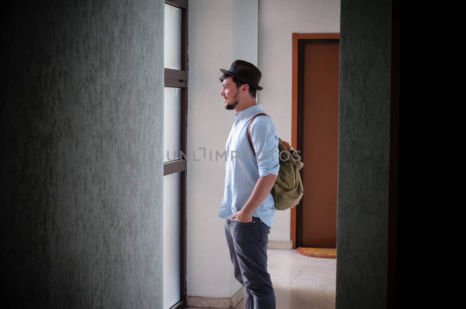 hipster young man posing in a hallway
