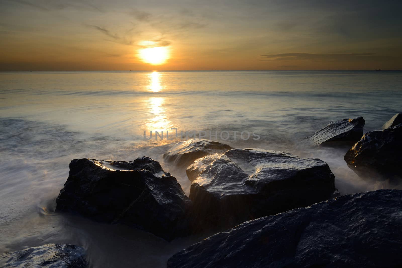 beautiful seascape of wave and rock at the sunrise