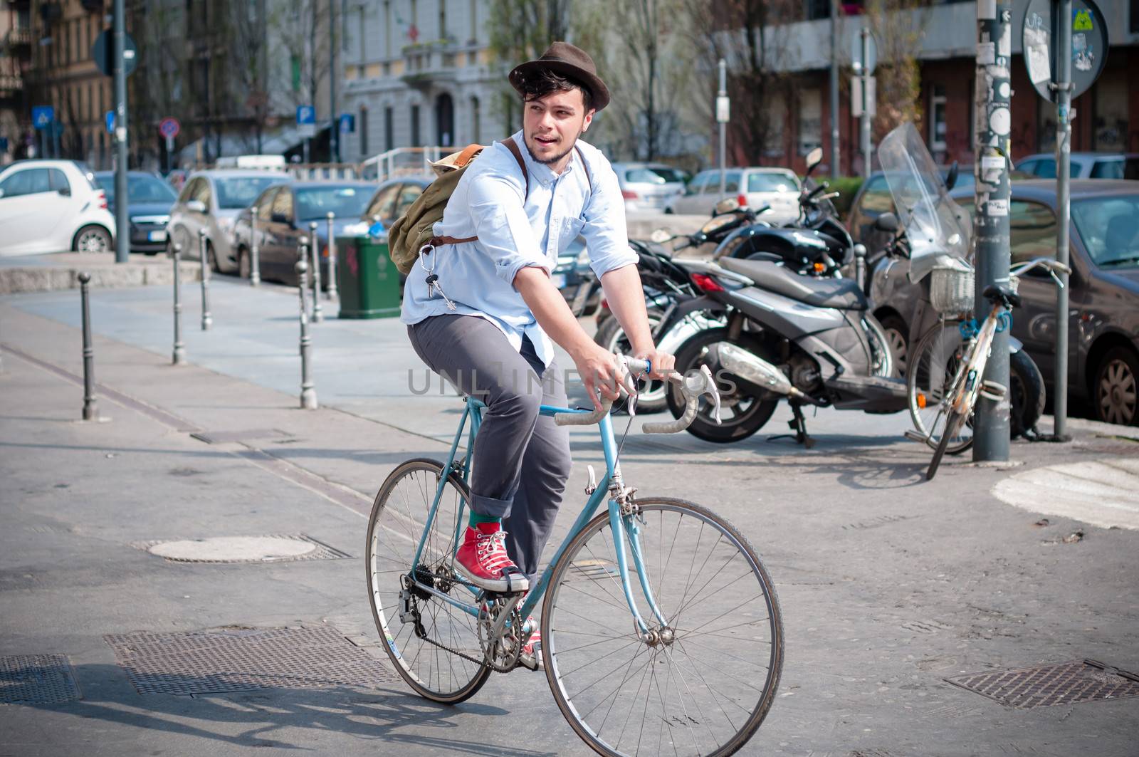 hipster young man on bike in the city