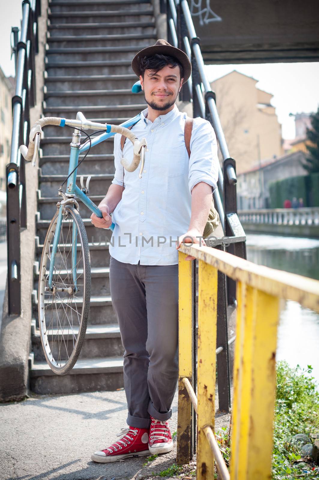 hipster young man on bike in the city