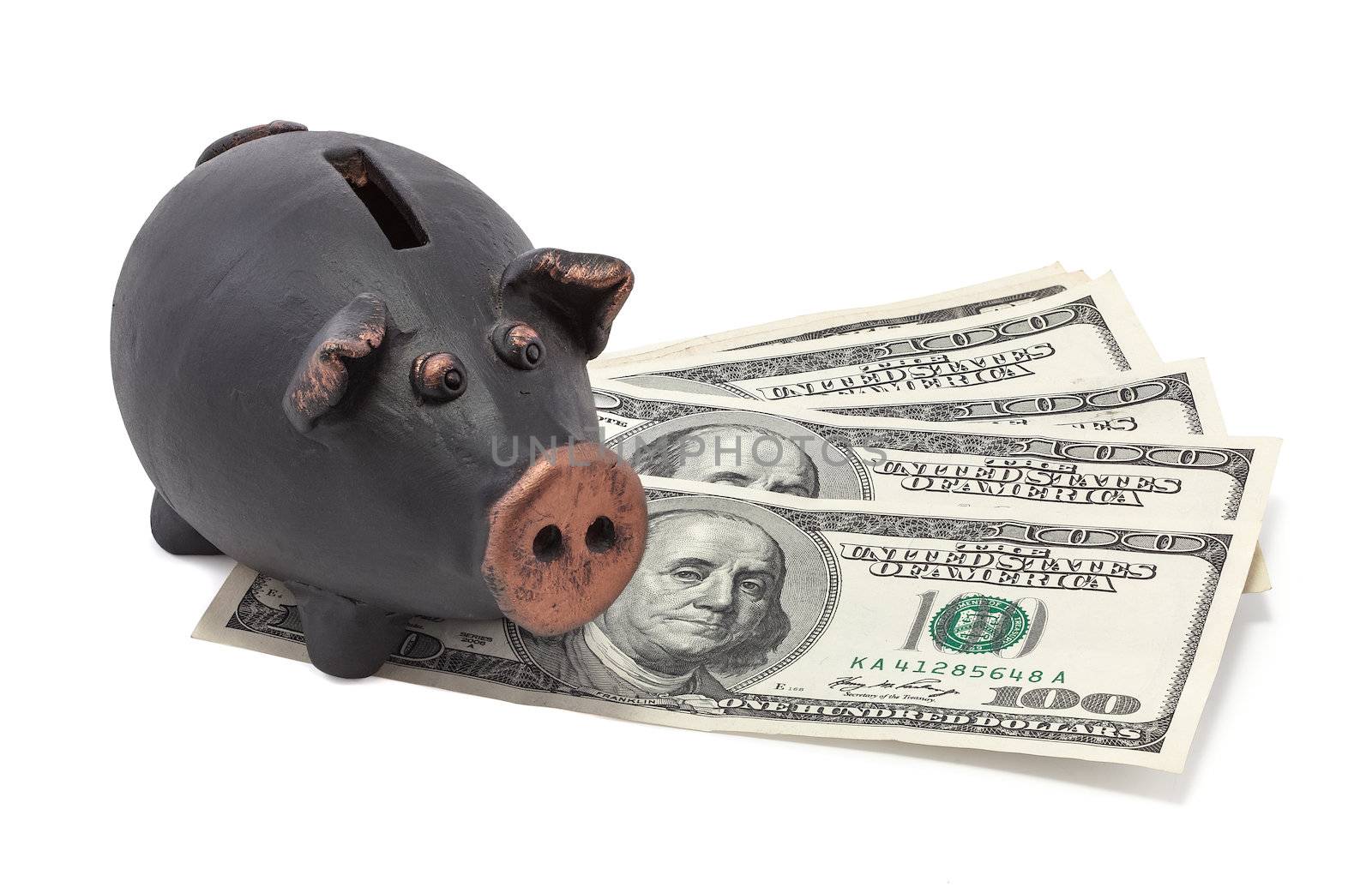 Money and black piggy bank on white background.