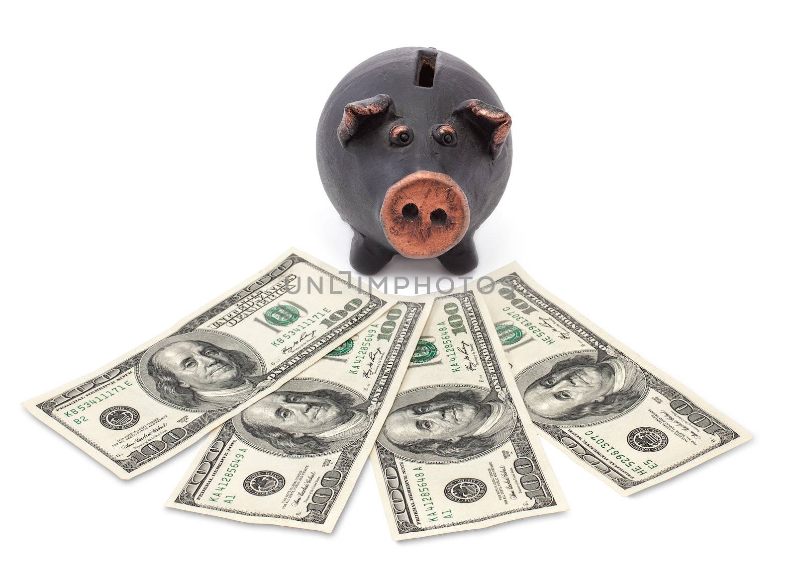 Money and black piggy bank on white background.