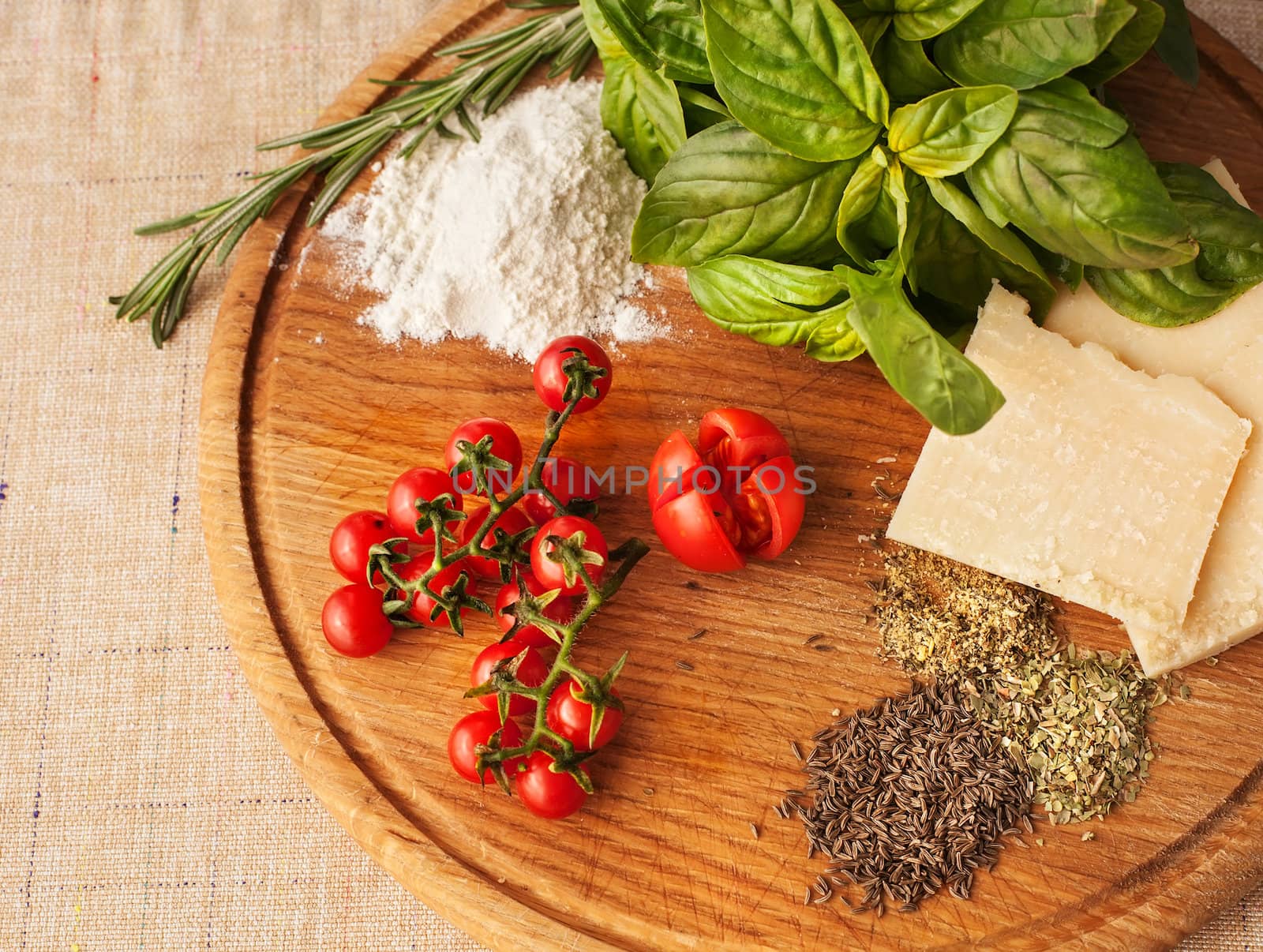 Ingredients of Italian cuisine. Cherry tomatoes, basil, rosemary, thyme,