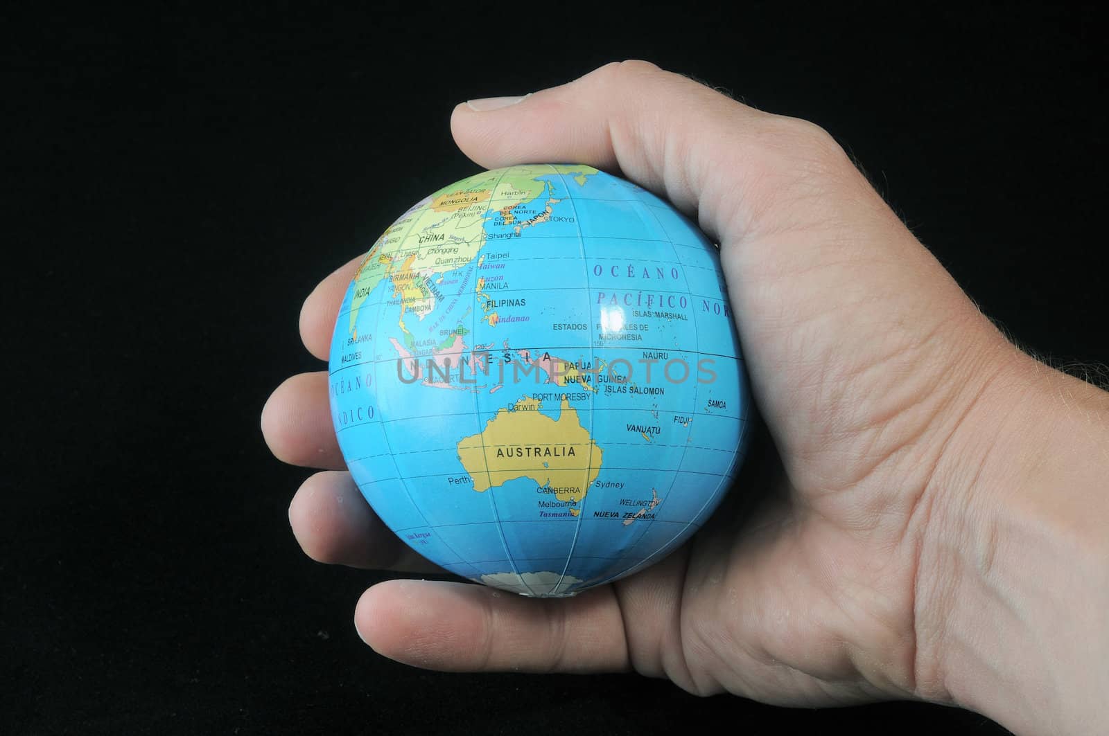 Globe in an  hand on a black background