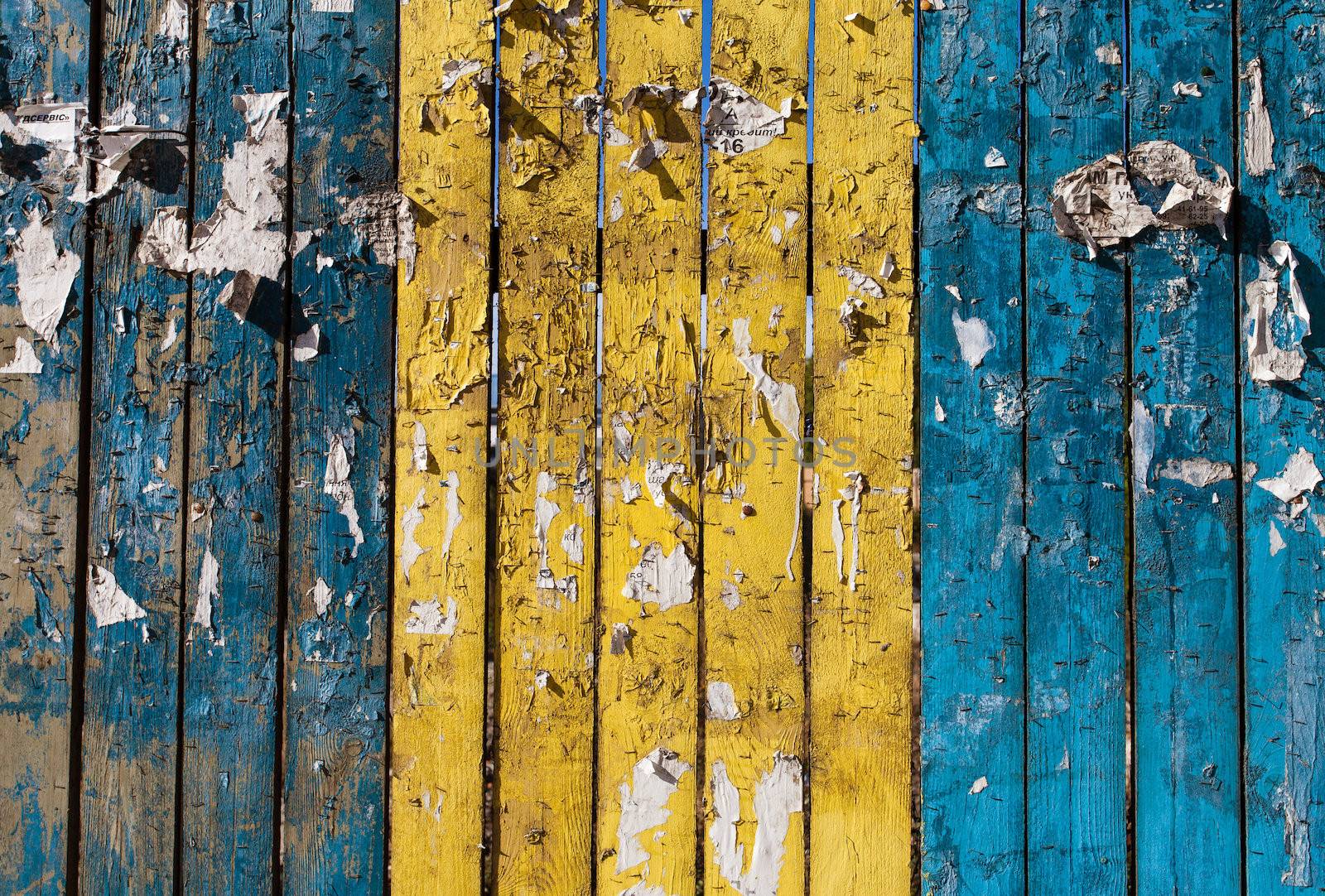 painted wooden fence with old ads