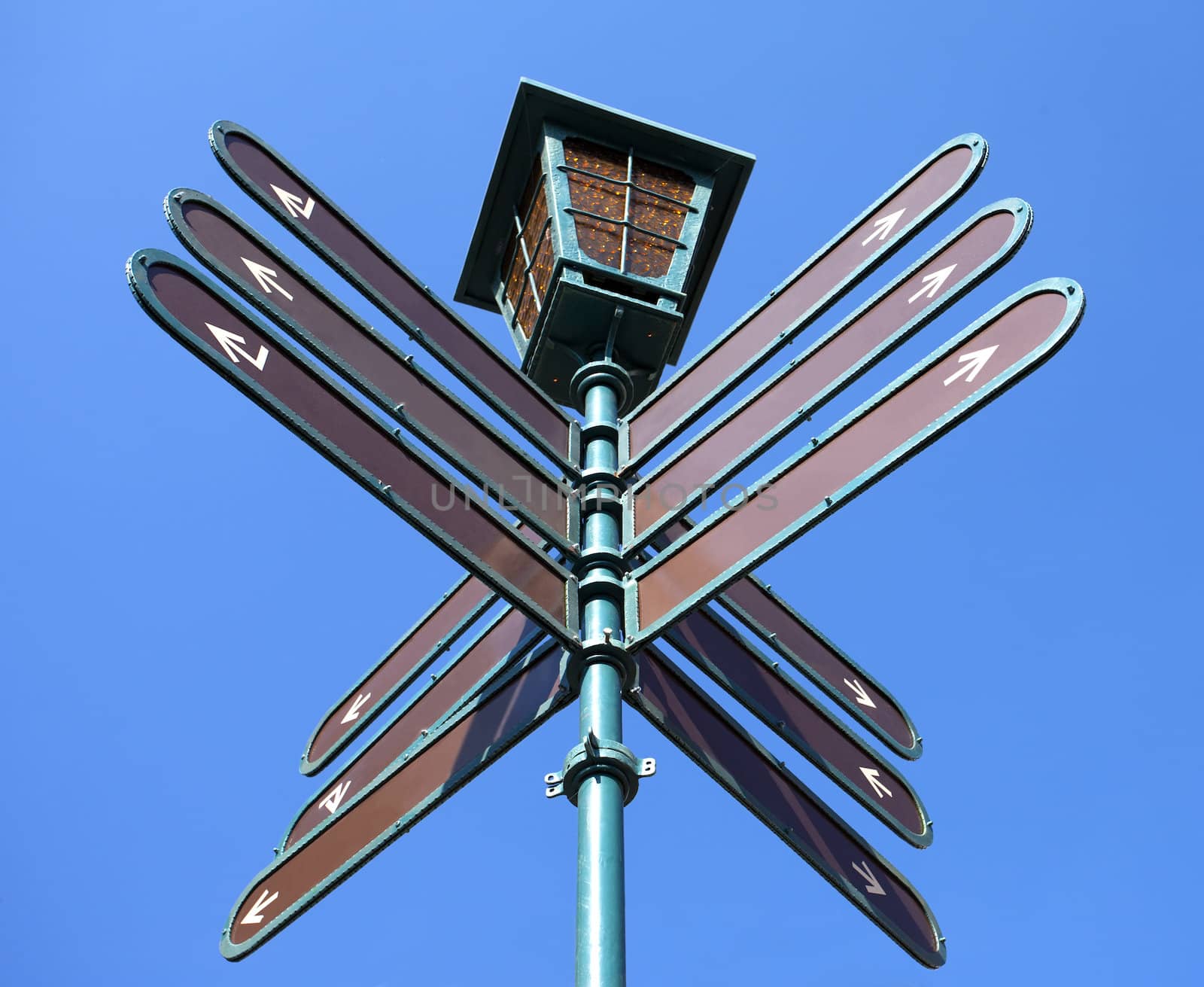 Blank directional road signs over blue sky