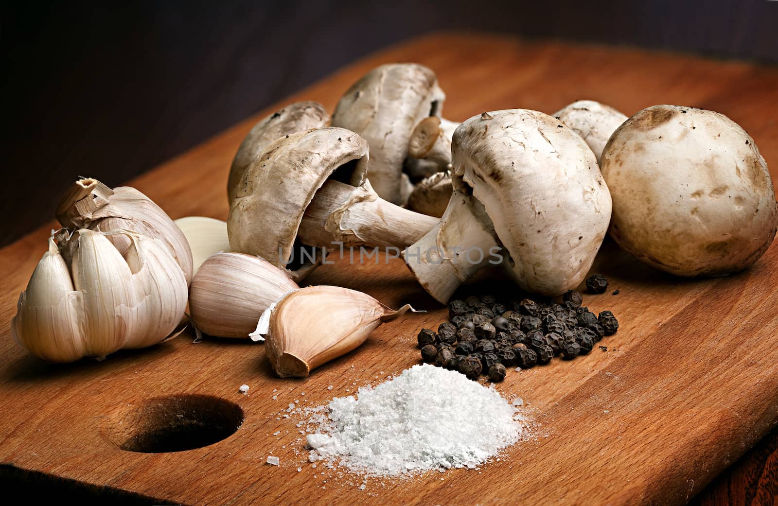 Still life with champignon mushrooms, salt, garlic and pepper