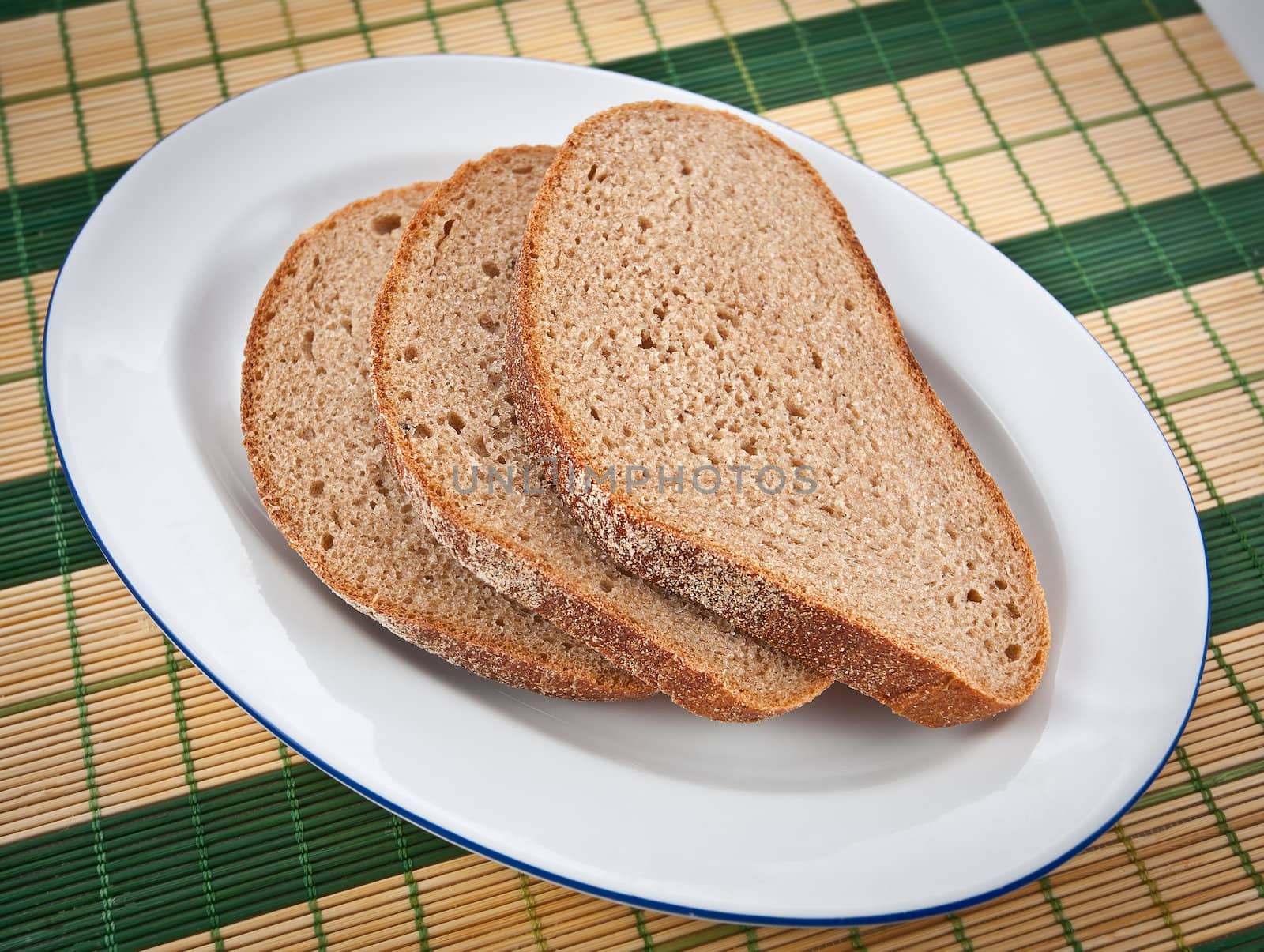 Three slices of brown bread on a plate