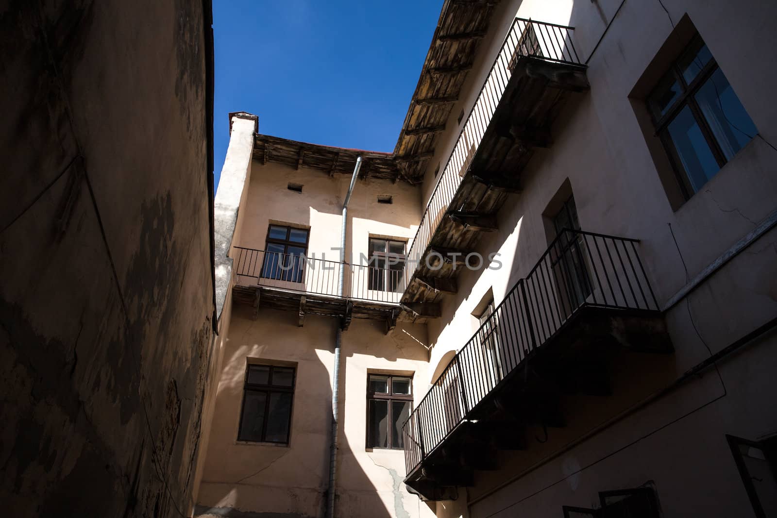 Illuminated by sun wall of the old house, the view from the courtyard. Lviv, Ukraine