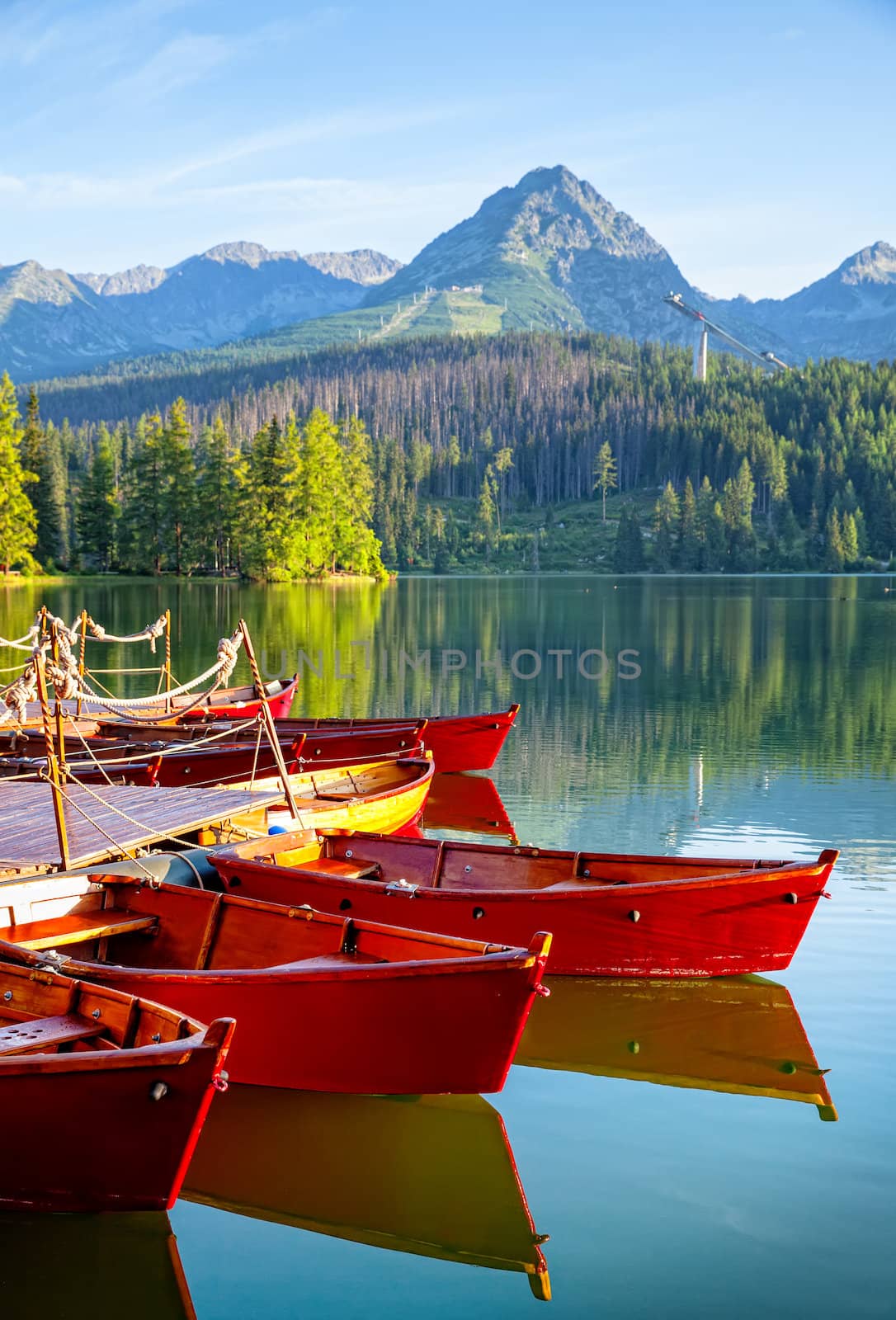 Red boats in mountain lake in High Tatra. Strbske pleso, Slovakia, Europe. Focos on boat