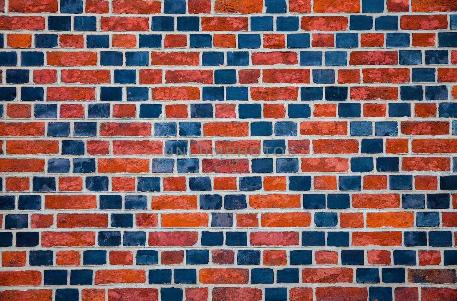 Decorative ornament made ������by red and black bricks on wall of an old house
