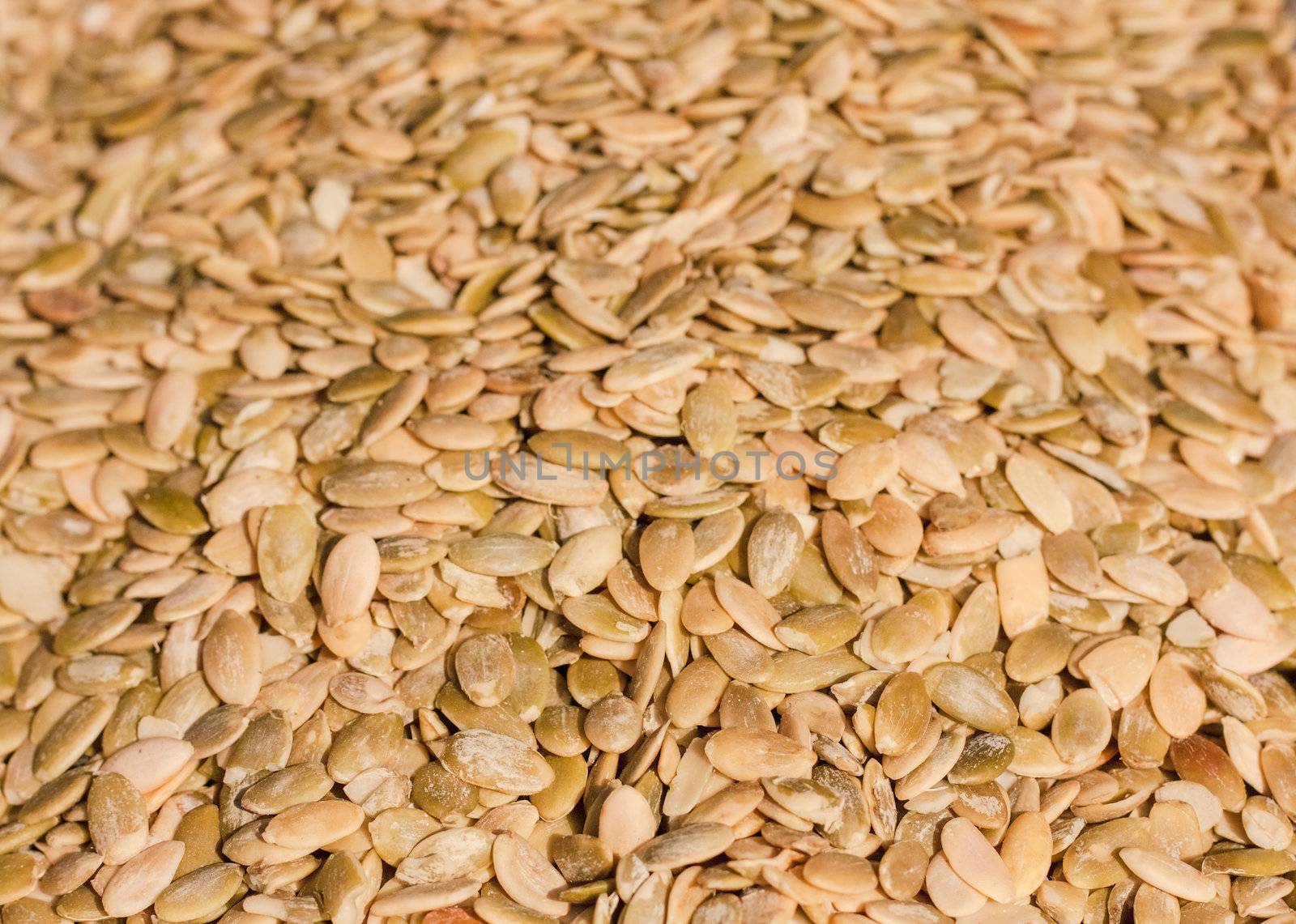 Close up of organic pumkin seeds / kernels. Background.