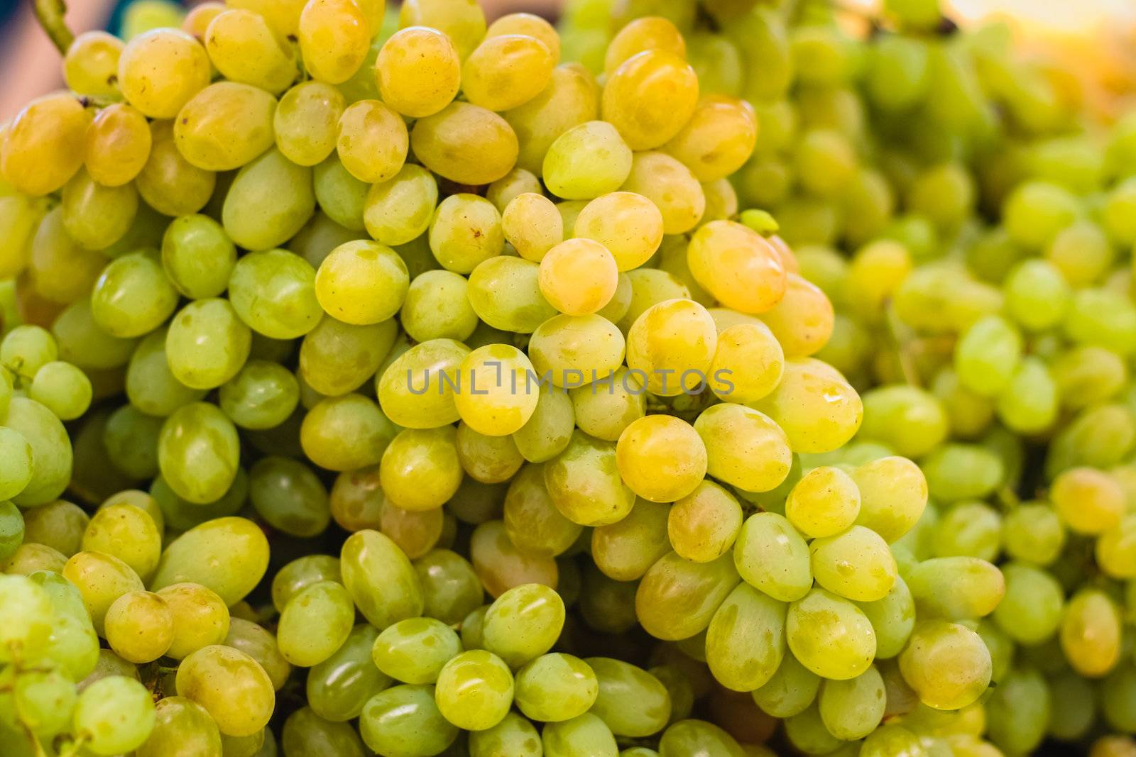 Fresh green grapes pile on the local market.  Crop Background by ryhor