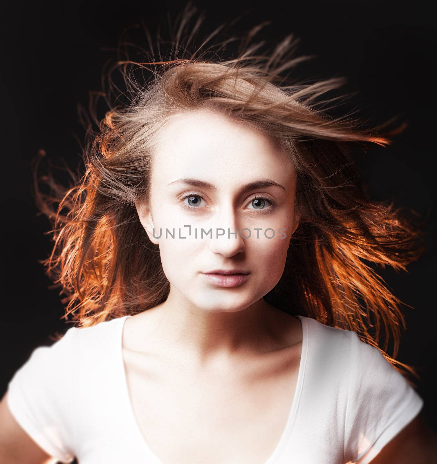 Portrait of a beautiful young woman on a dark background