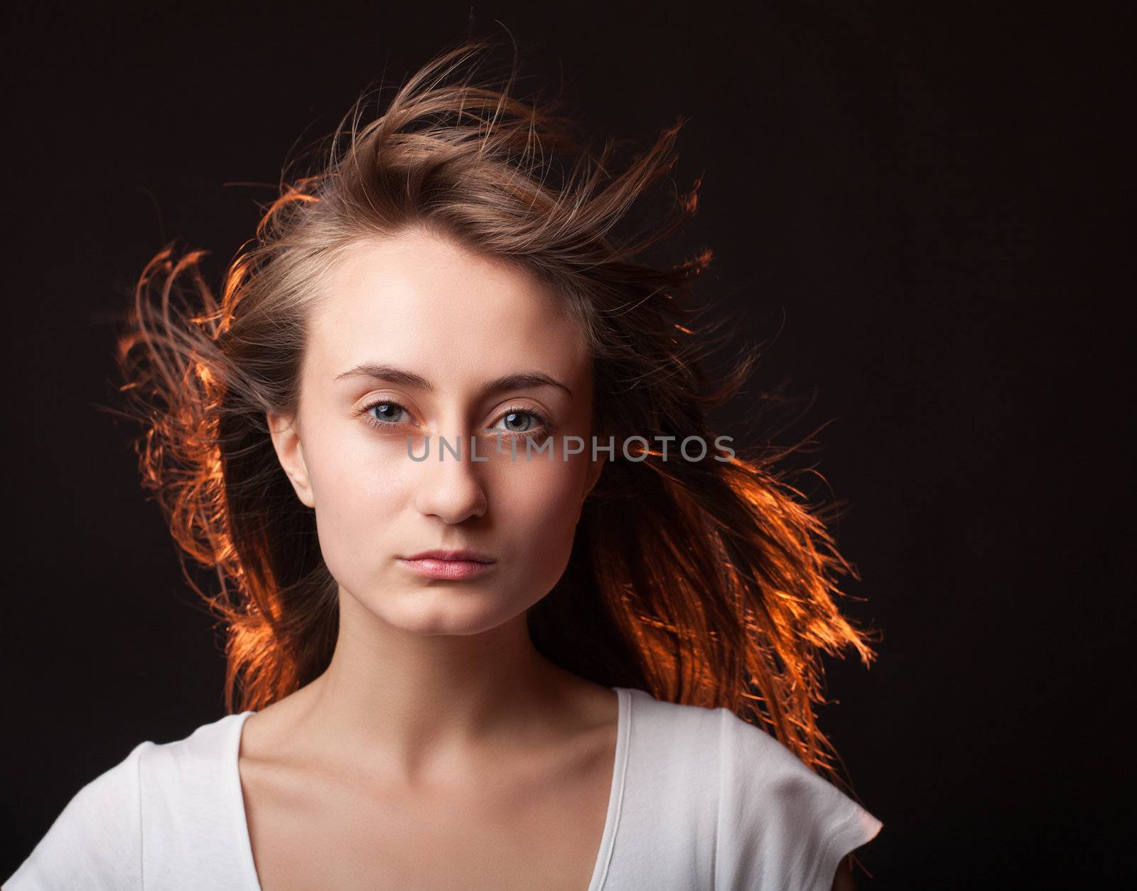 Portrait of a beautiful young woman on a dark background