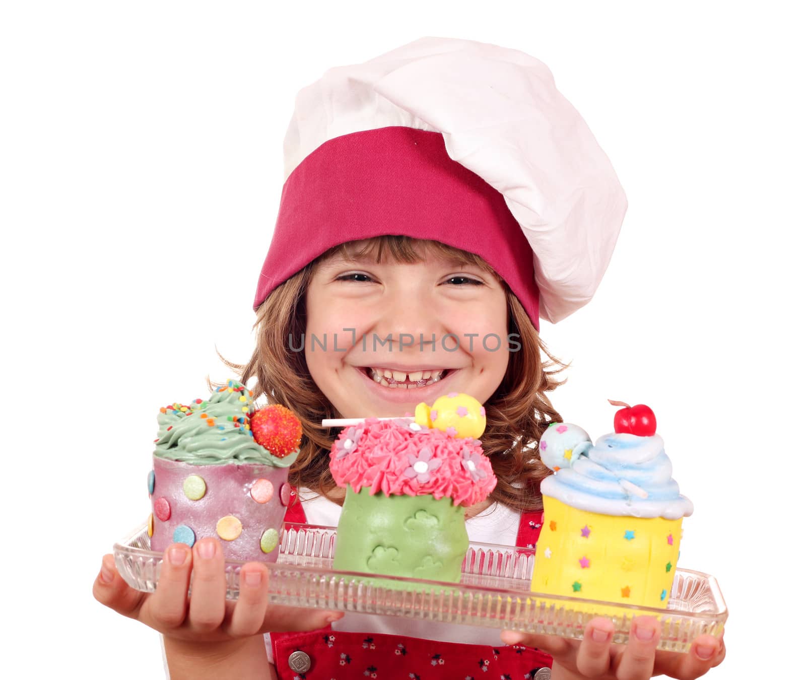 happy little girl cook with sweet cupcakes