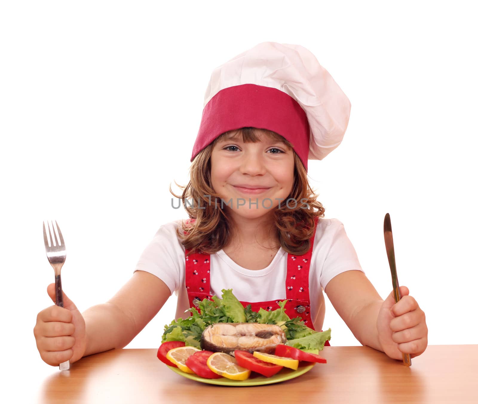 little girl cook with salmon seafood on table by goce