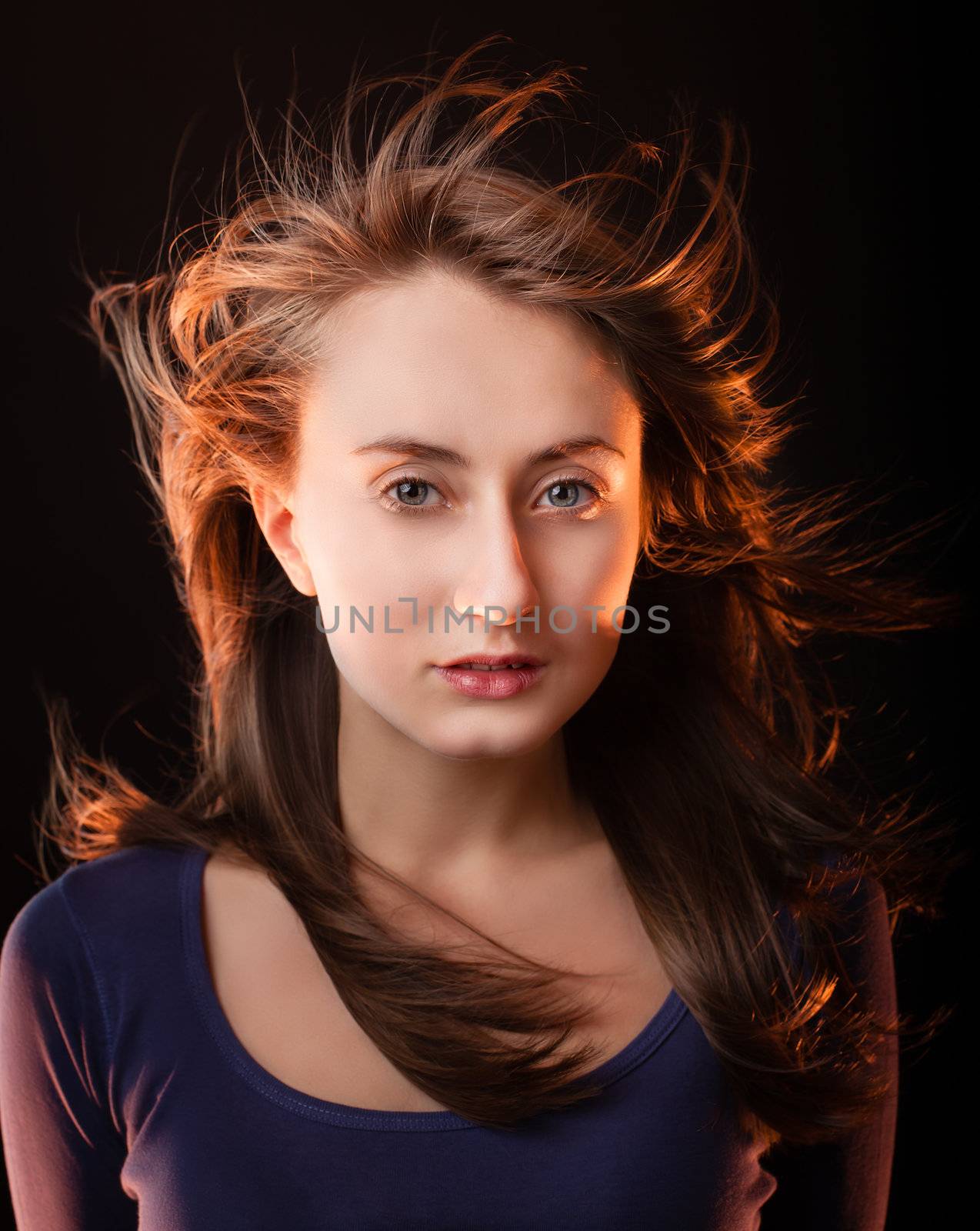 Portrait of a beautiful young woman on a dark background