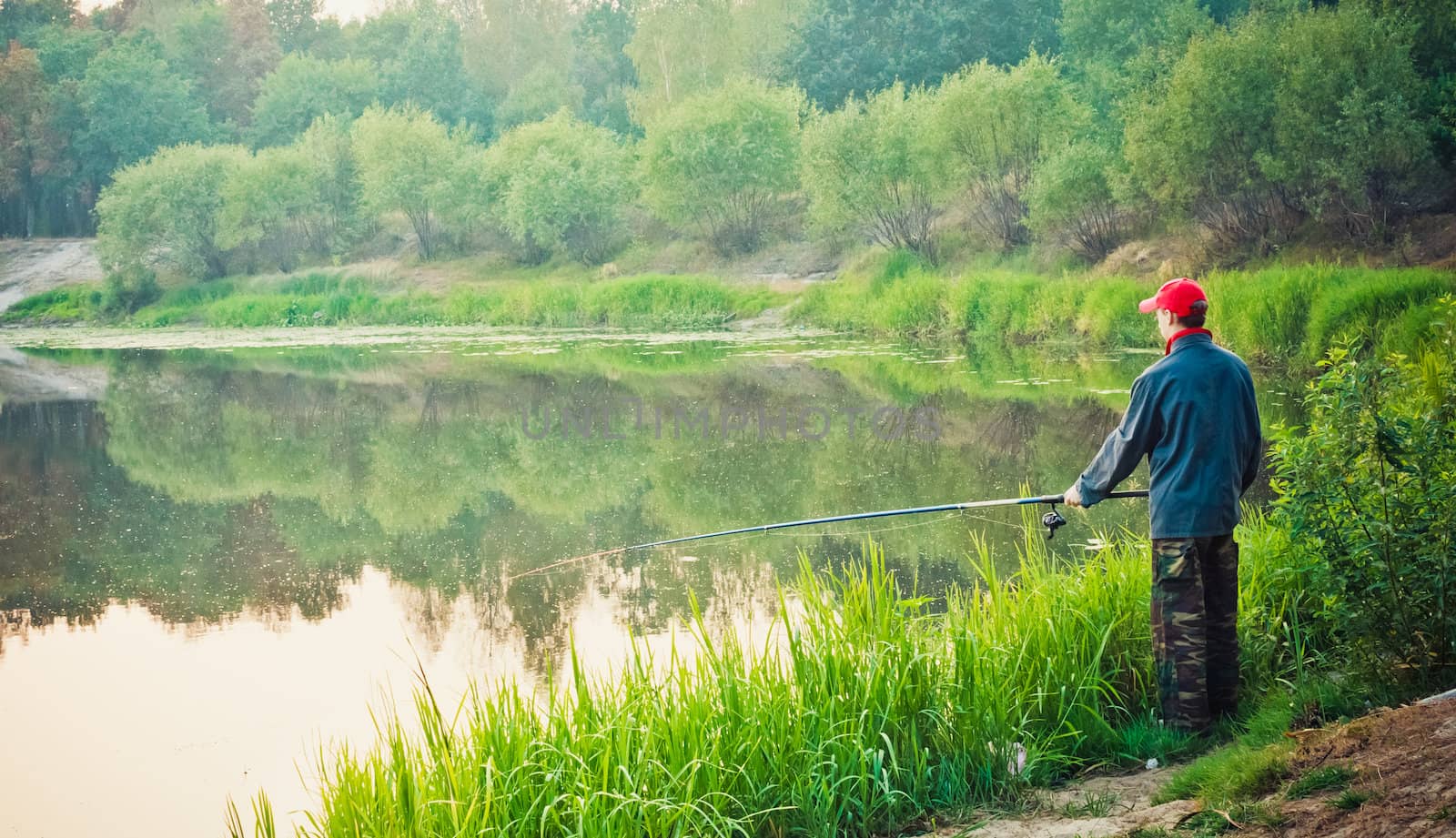 Fisherman Casting On Calm River by ryhor