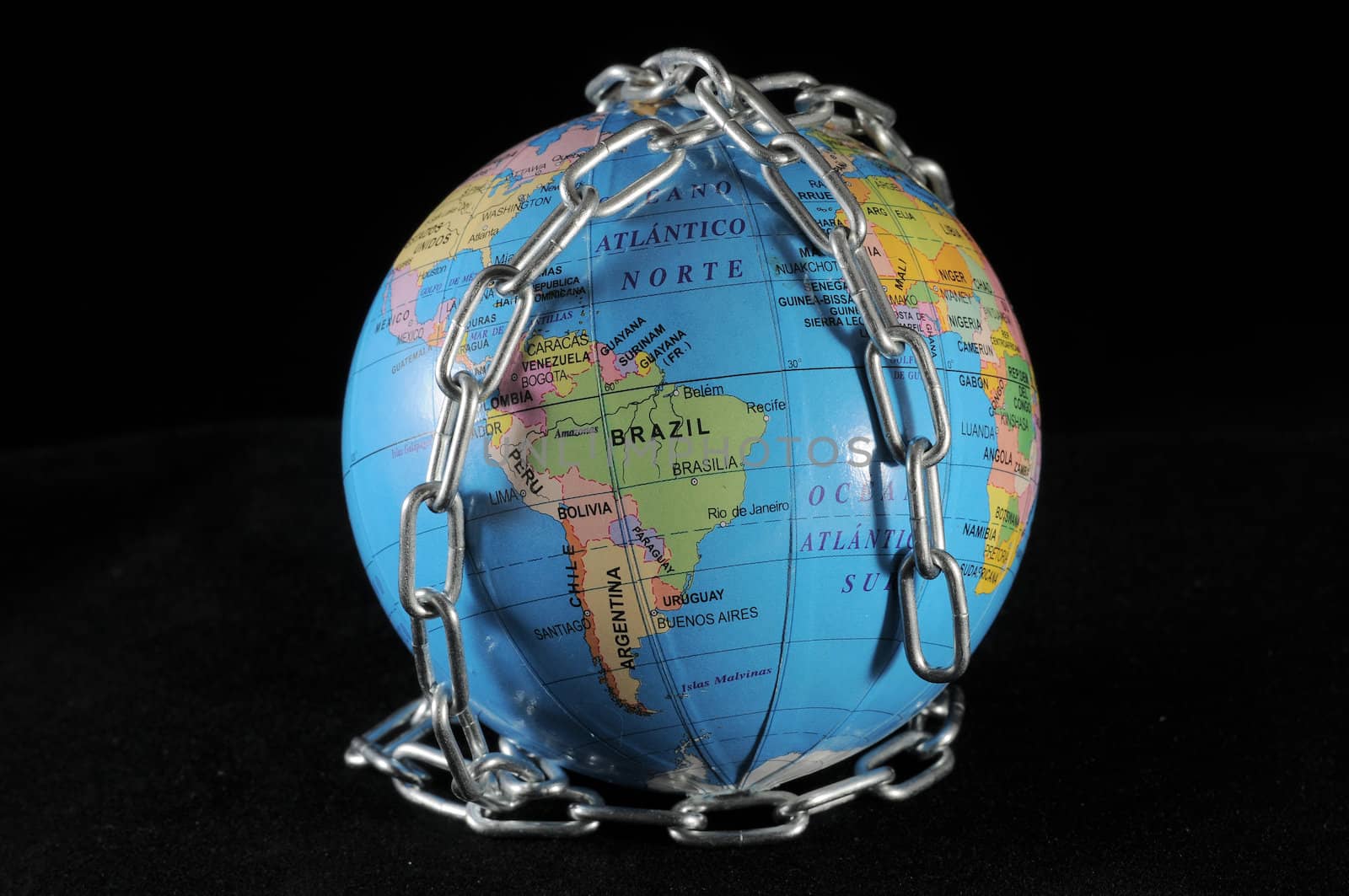 World in chains that represents the crisis on a black backgound 