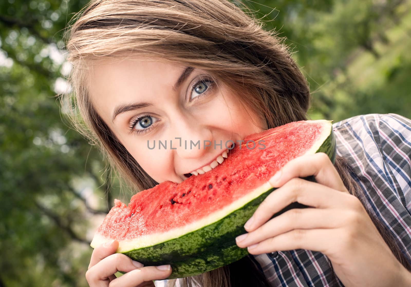 Young woman with watermelon outdoors