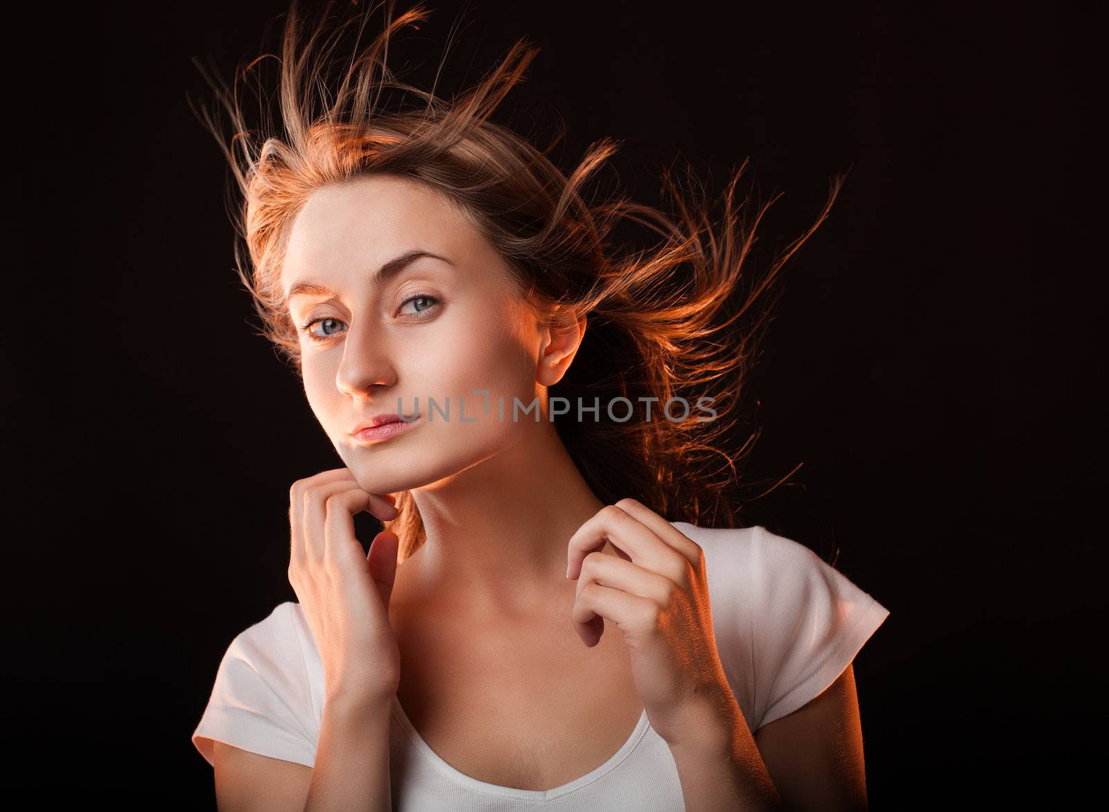 Portrait of a beautiful young woman on a dark background