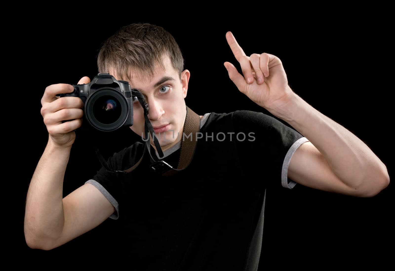 Young photographer at work isolated on black background