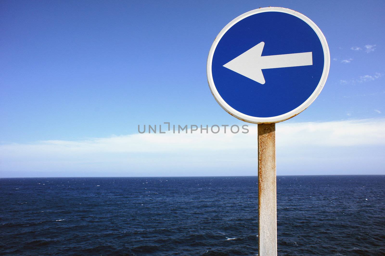 A Blue Direction Sign Indicating the Direction of Waves 