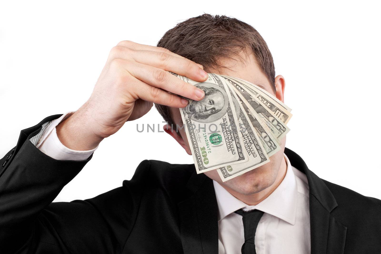 Businessman holding money with face behind dollars isolated on white